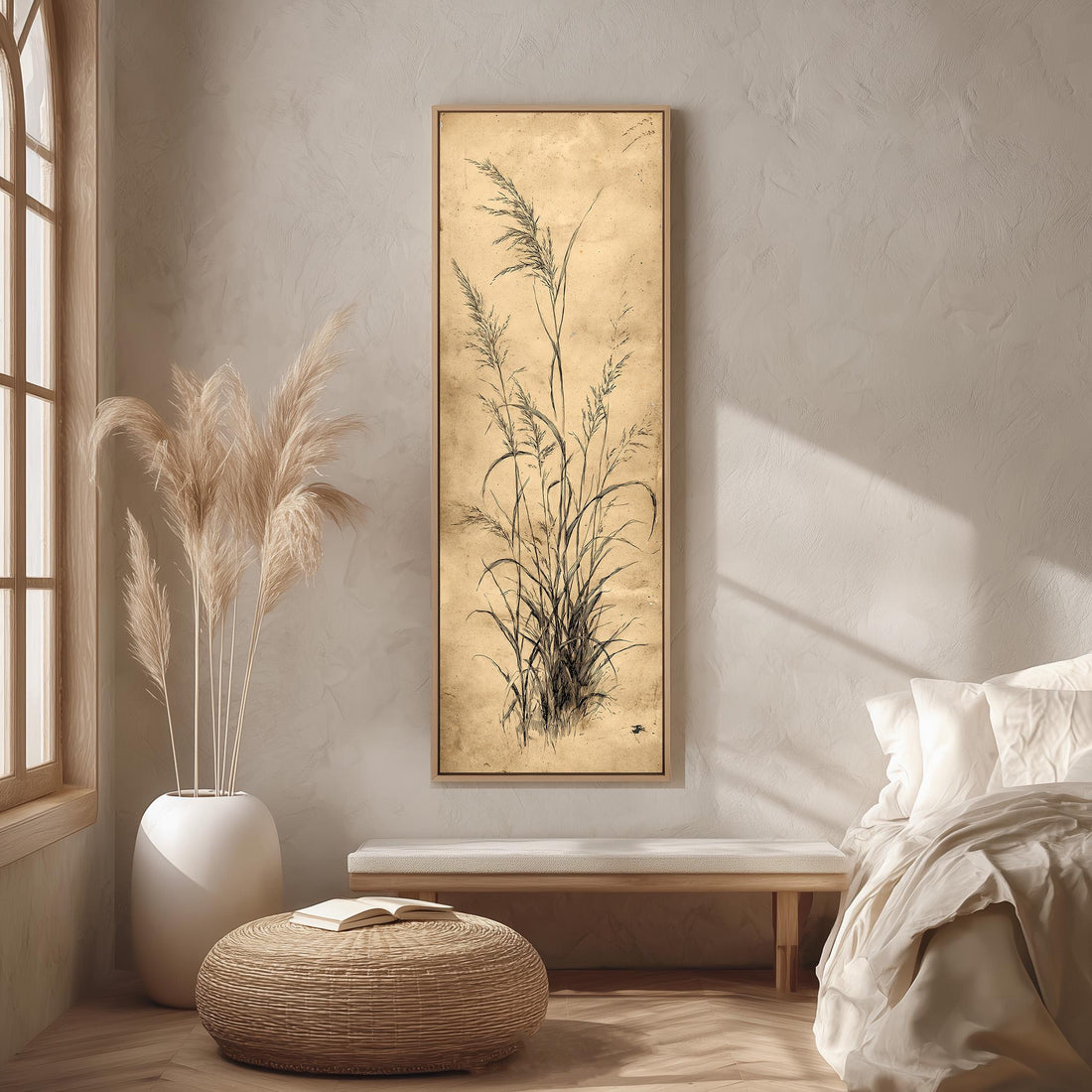 a serene and minimalist bedroom interior, featuring a large framed artwork of tall grasses hanging on the wall, a white bed with a white pillow, a white vase with tall grasses, and a woven ottoman.