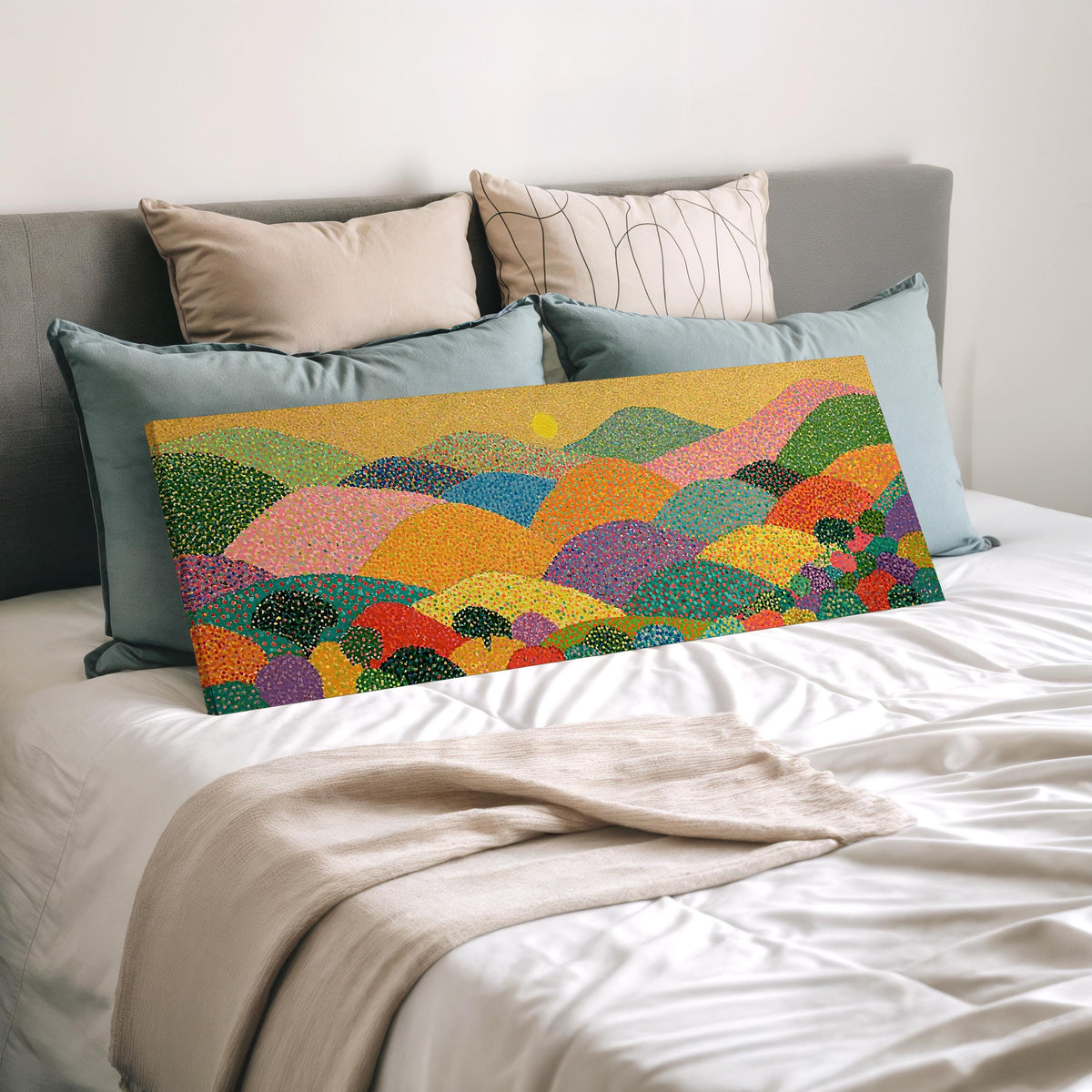 Dotted rainbow hills at sunset wide panoramic canvas print laid on a bed to show its size