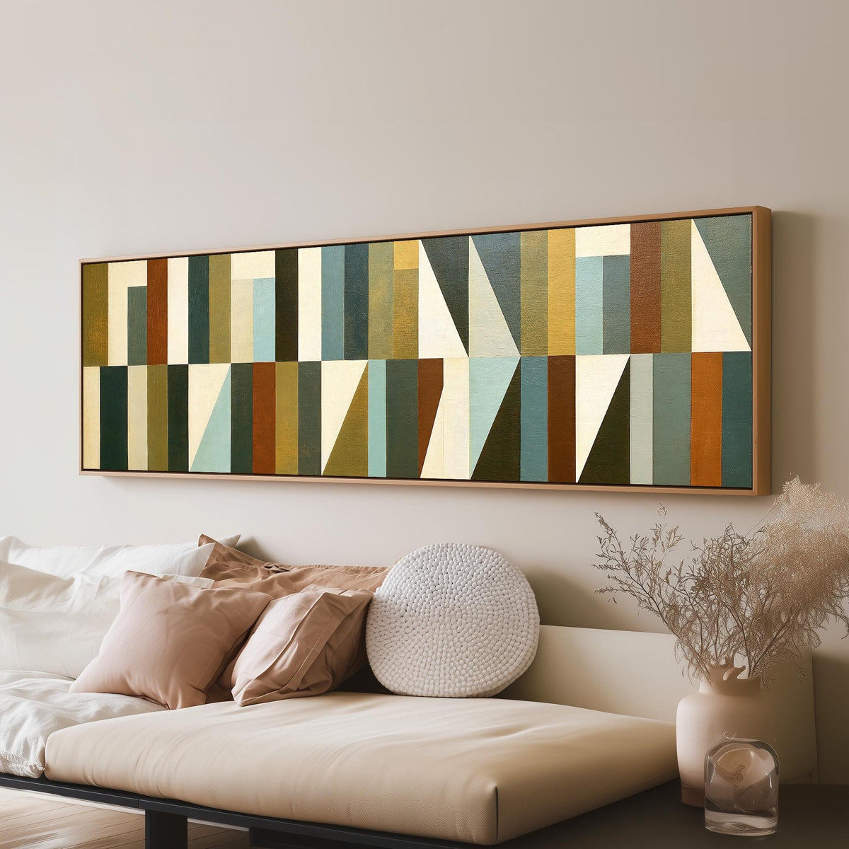 Earth tone geometric triangles panoramic canvas print above a sofa in a living room