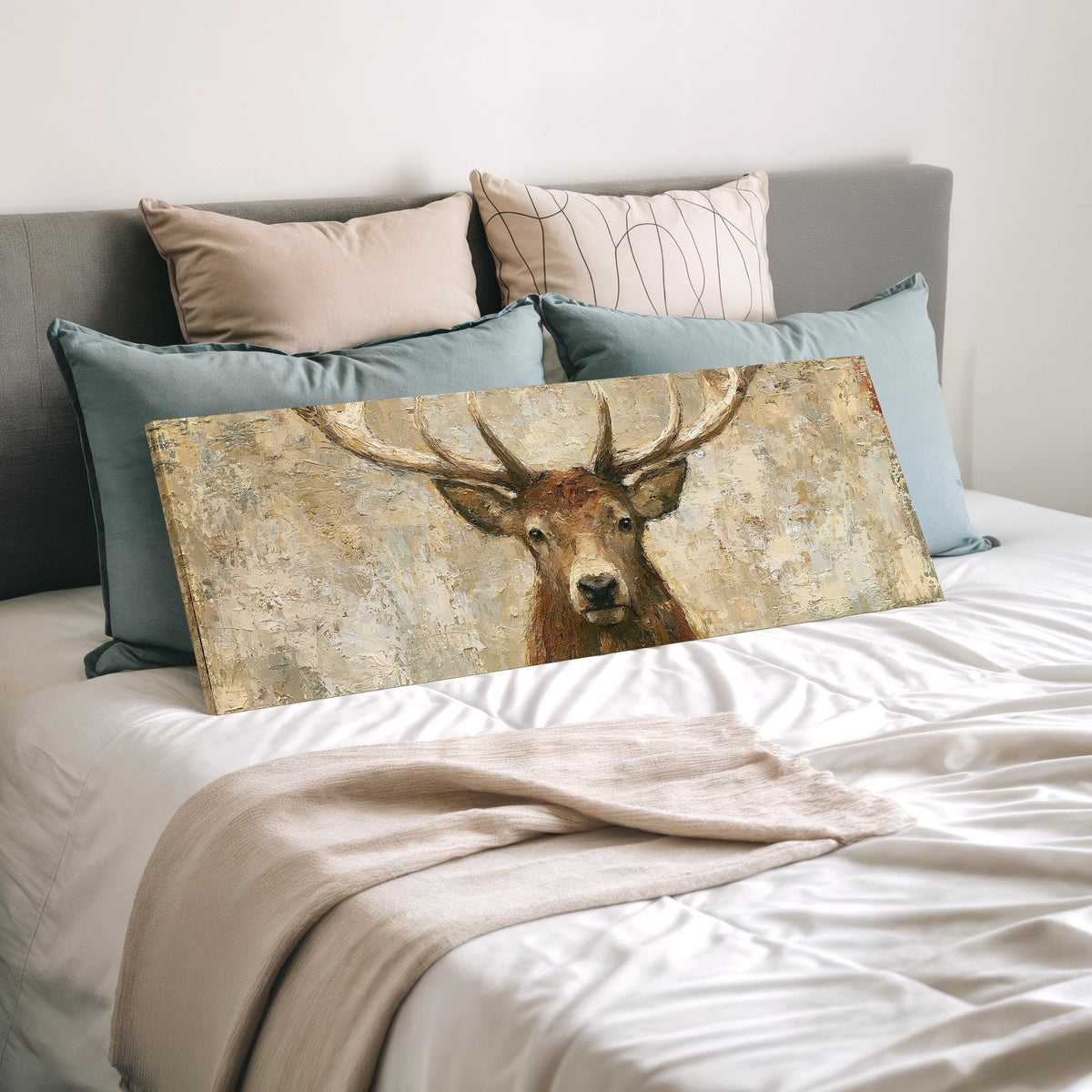 Rustic stag portrait wide panoramic canvas print laid on a bed to show its size