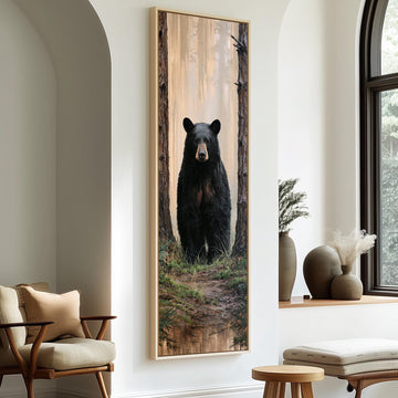 Black bear standing in a foggy forest long vertical canvas print in a sunlit living space