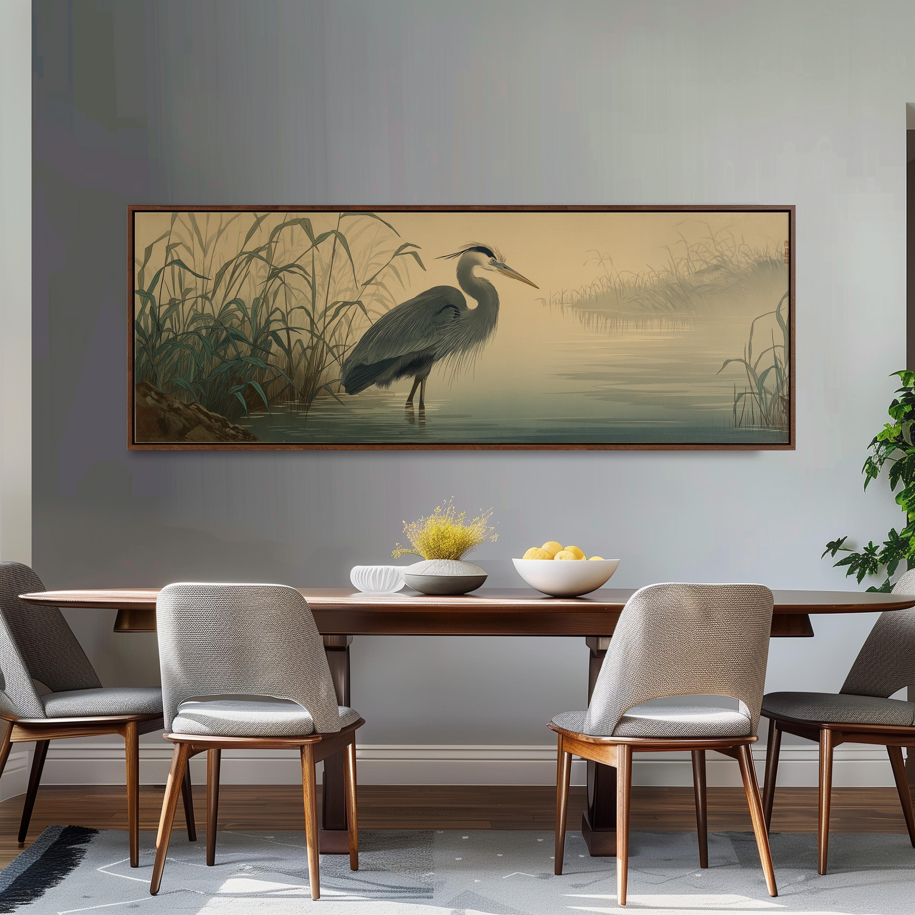 a dining room with a large painting of a heron standing in a body of water on the wall above a wooden dining table with four chairs.