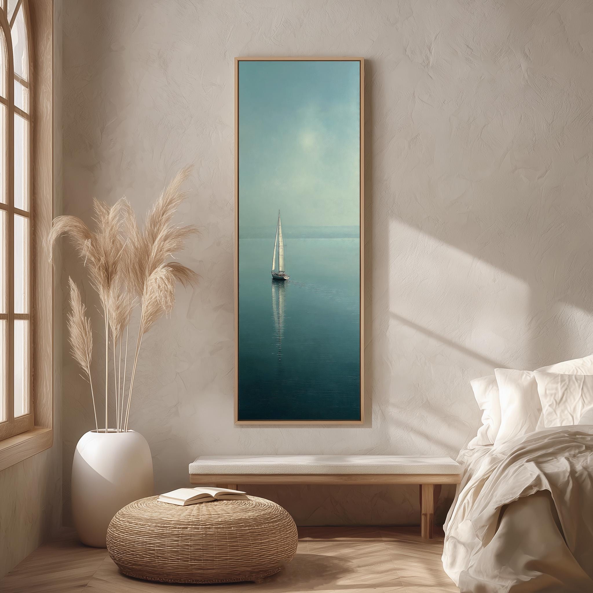 a serene indoor setting with a large painting of a sailboat on the wall, a white sofa, a woven ottoman, and a potted plant.