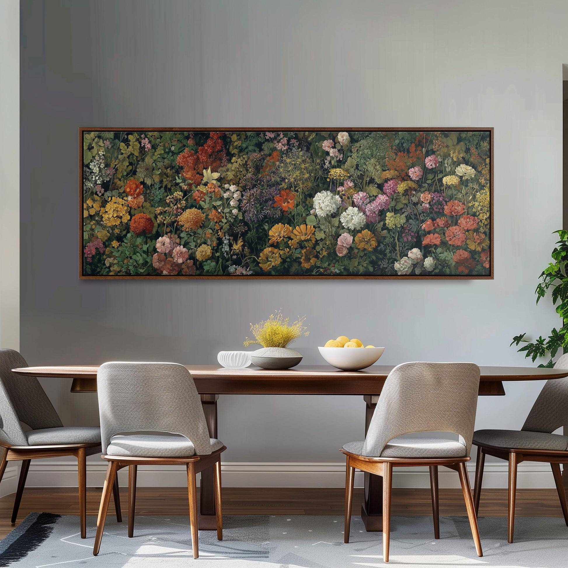 a dining room with a large floral painting hanging on the wall above a wooden table with four chairs. The table is set with a bowl of fruit and a vase of flowers, creating a cozy and inviting atmosphere.