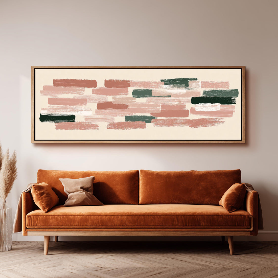 a large abstract painting hanging on a wall above a brown sofa with orange cushions.