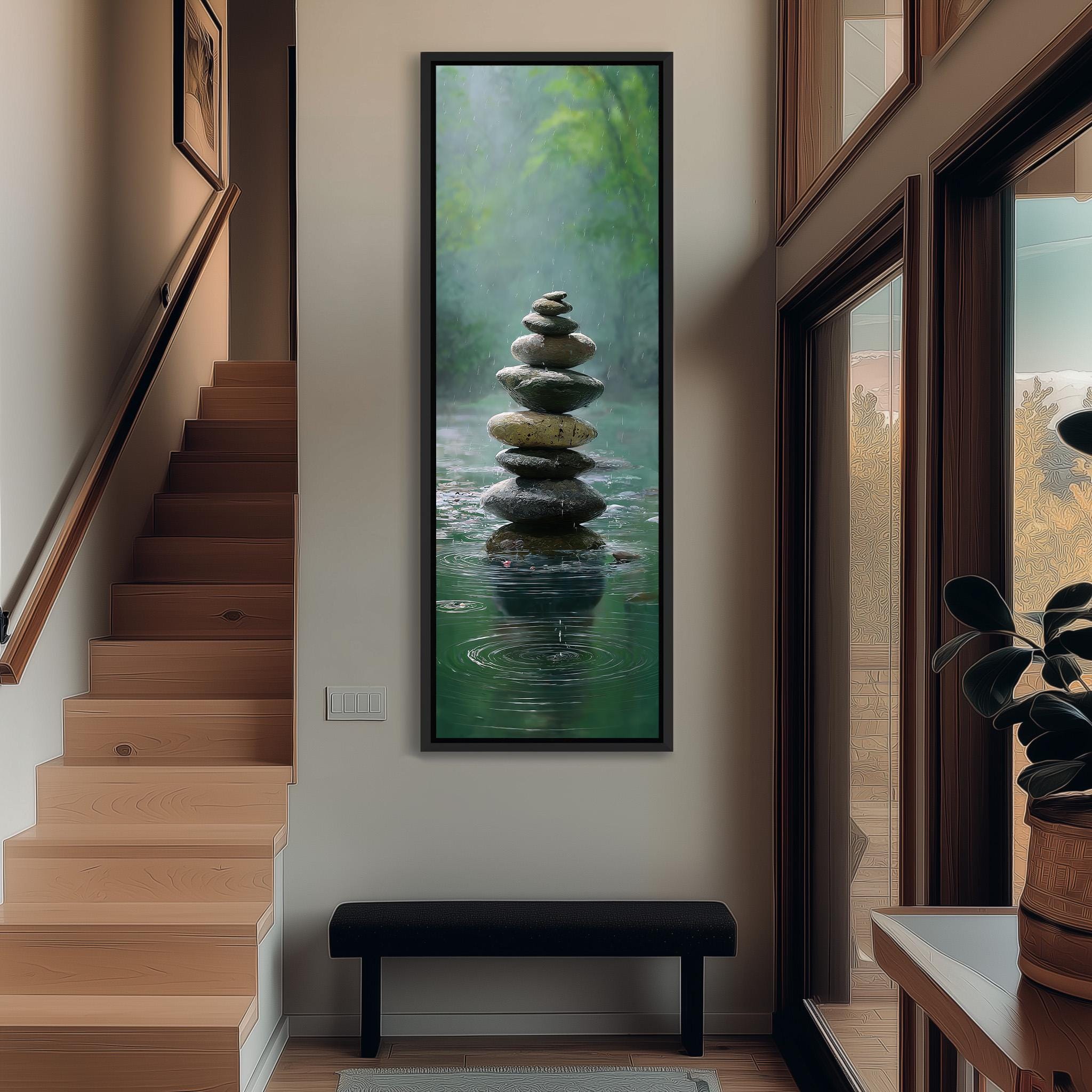 a serene indoor setting with a large painting of a rock formation in water hanging on the wall. The painting depicts a stack of rocks balanced on top of each other, creating a sense of harmony and tranquility. The painting is framed in a black frame, which contrasts with the white wall behind it. The room has wooden stairs leading up to the painting, and a bench is placed in front of the painting, inviting viewers to sit and appreciate the artwork.