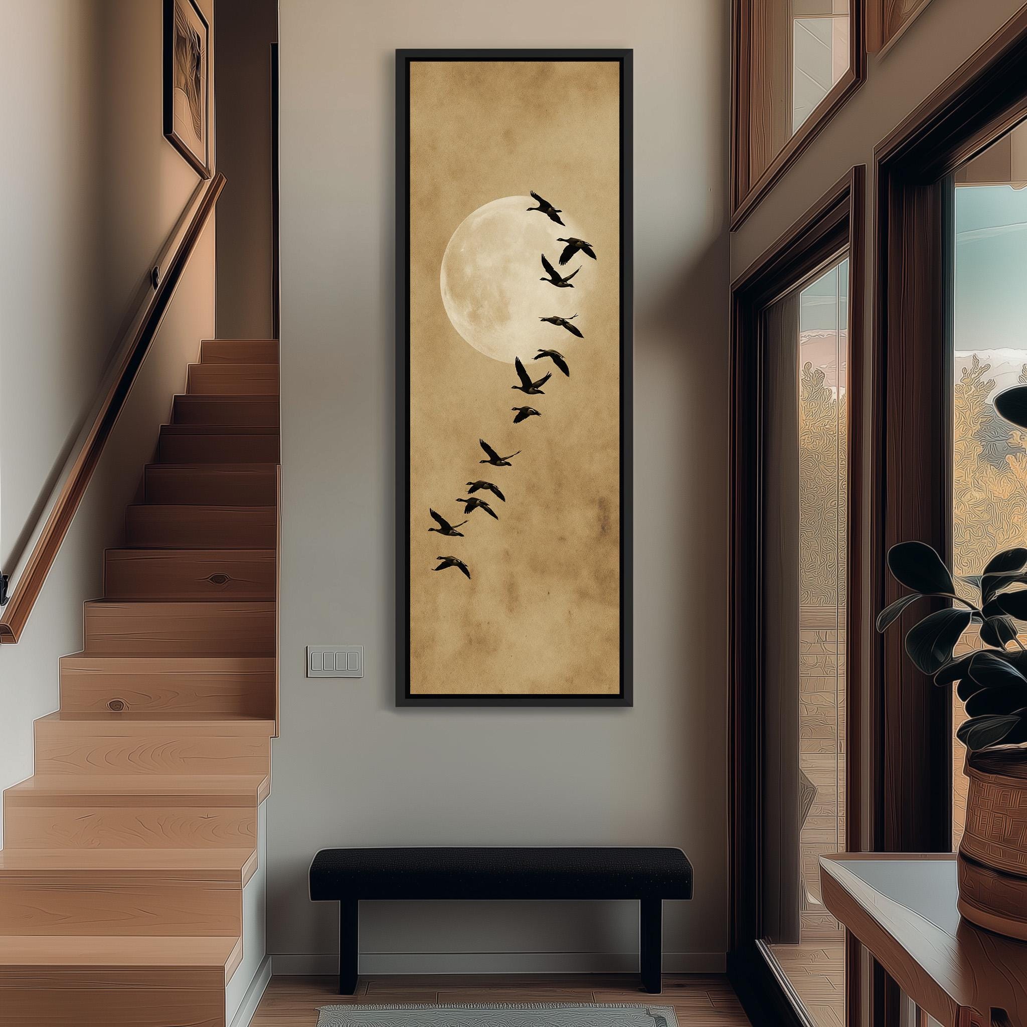 a hallway with a large framed picture of a flock of birds flying across a moonlit sky, hanging on the wall above a bench.