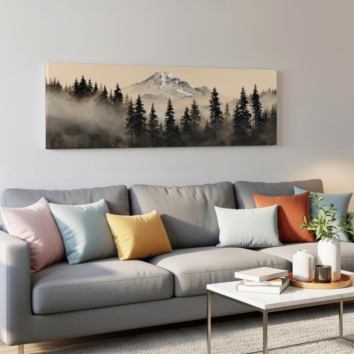 Foggy pine forest below a snowy mountain panoramic canvas print above a grey sofa in a living room