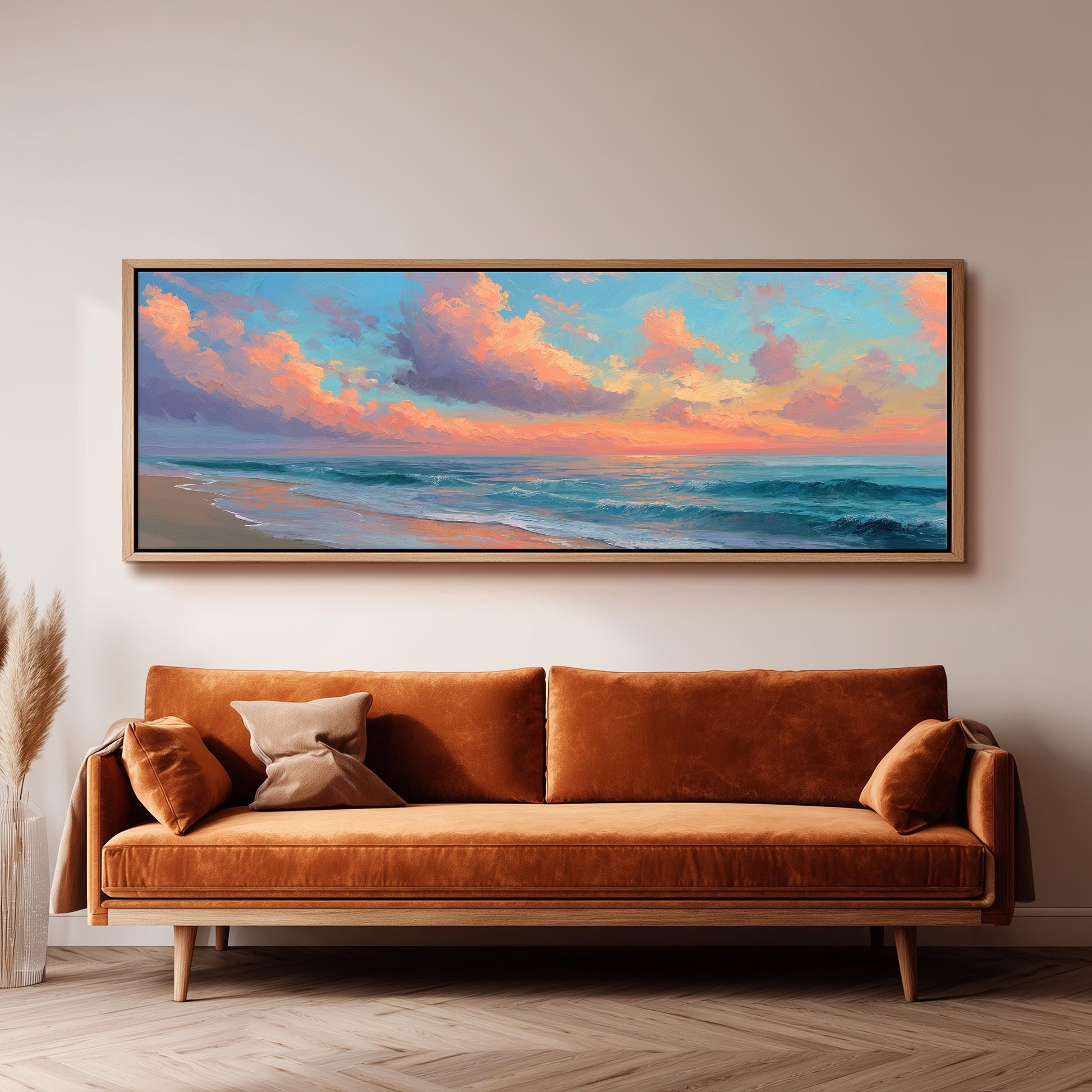 a large, framed painting of a beach scene hanging on a wall above a brown sofa.