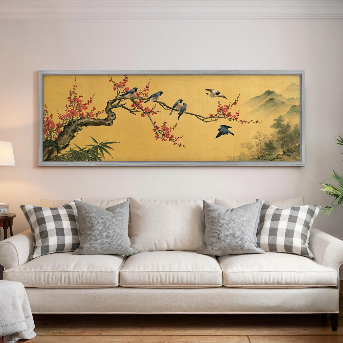 Birds on a plum blossom branch on gold panoramic canvas print above a white sofa in a bright living room