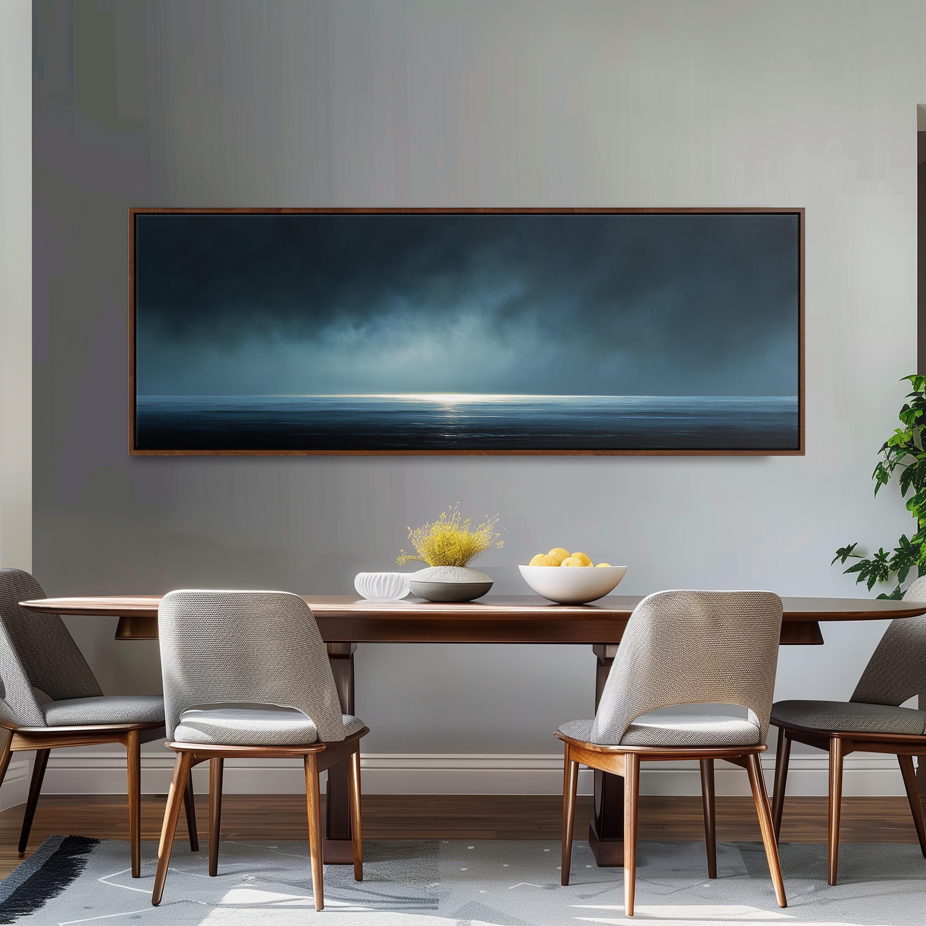 a dining room with a large painting of a stormy ocean scene hanging on the wall above a wooden dining table with four chairs. The table is set with a bowl of fruit and a vase of flowers, creating a cozy and inviting atmosphere.