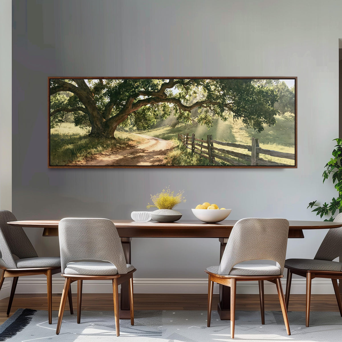 Sunlit country lane with oak trees and a wooden fence long horizontal canvas print above a dining table