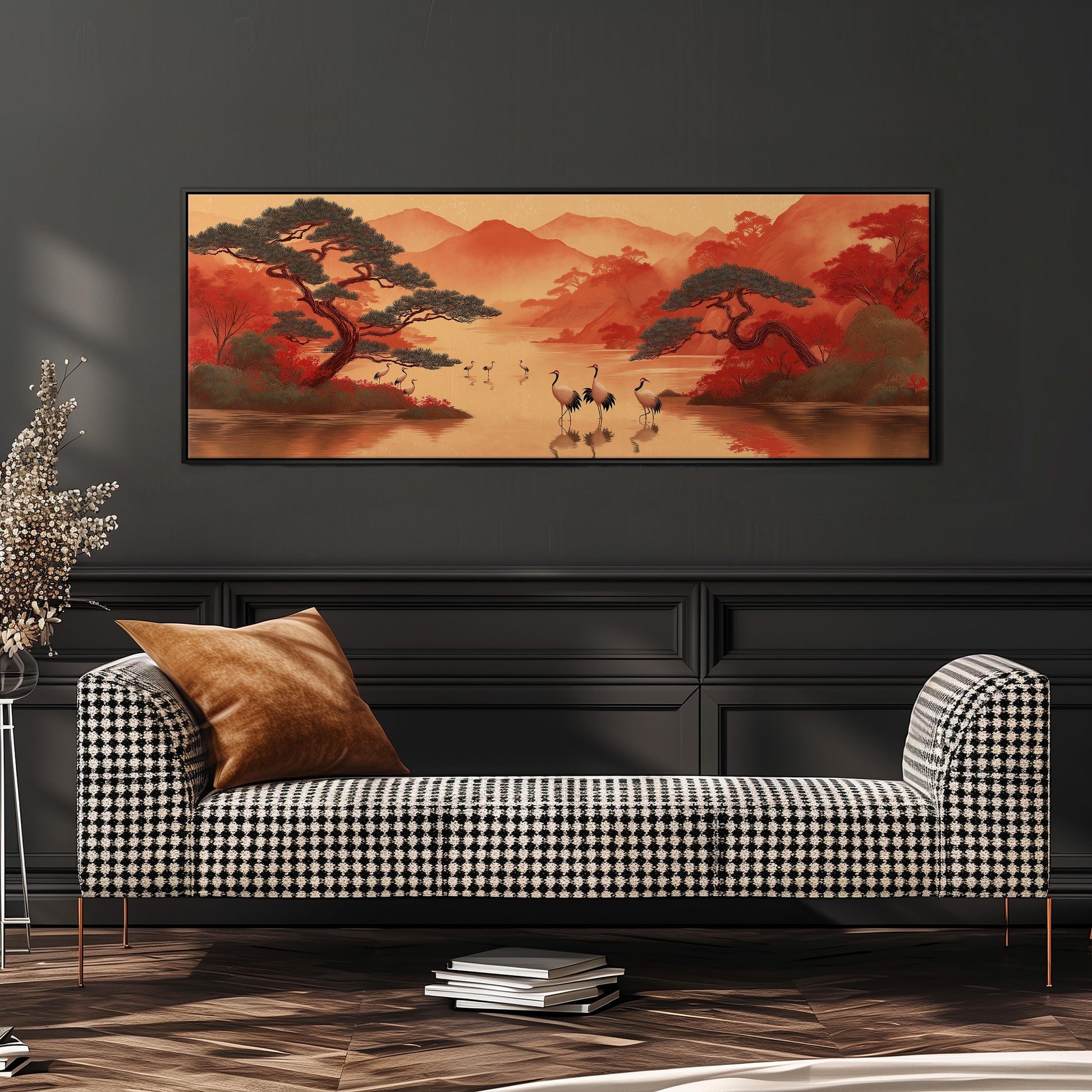 a large, framed painting of a serene landscape with a lake, mountains, and trees, hanging on a wall above a black and white checkered sofa.