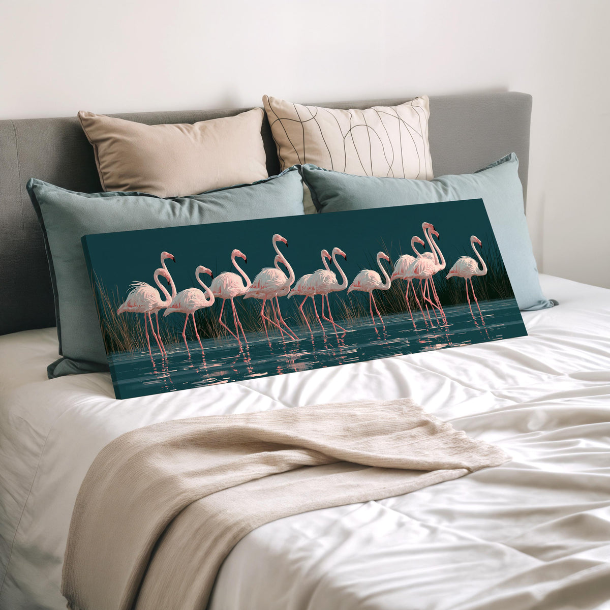 Blush pink flamingos on dark teal water wide panoramic canvas print laid on a bed to show its size