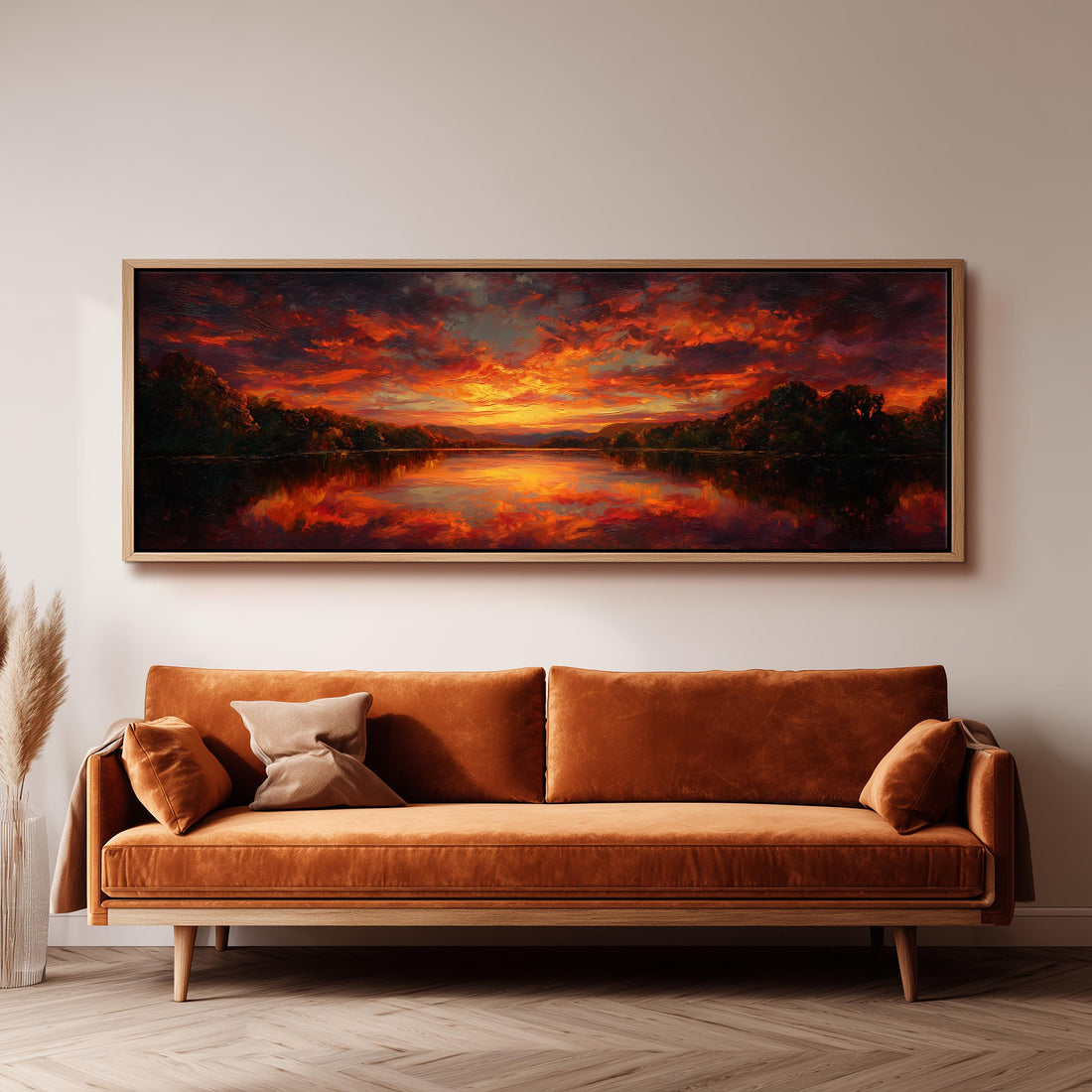 a large, framed painting of a sunset landscape hanging on a wall above a brown sofa.