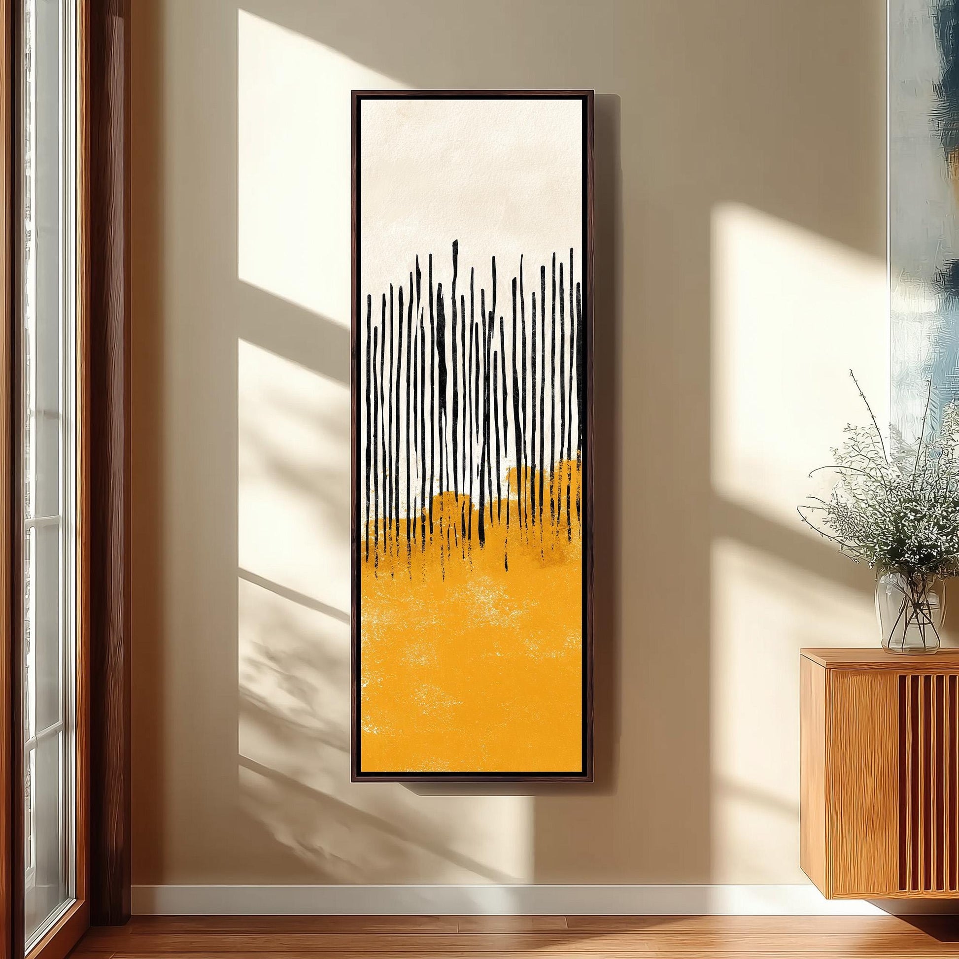 a large abstract painting hanging on a wall, with a wooden cabinet and a vase of flowers to the right of the painting.