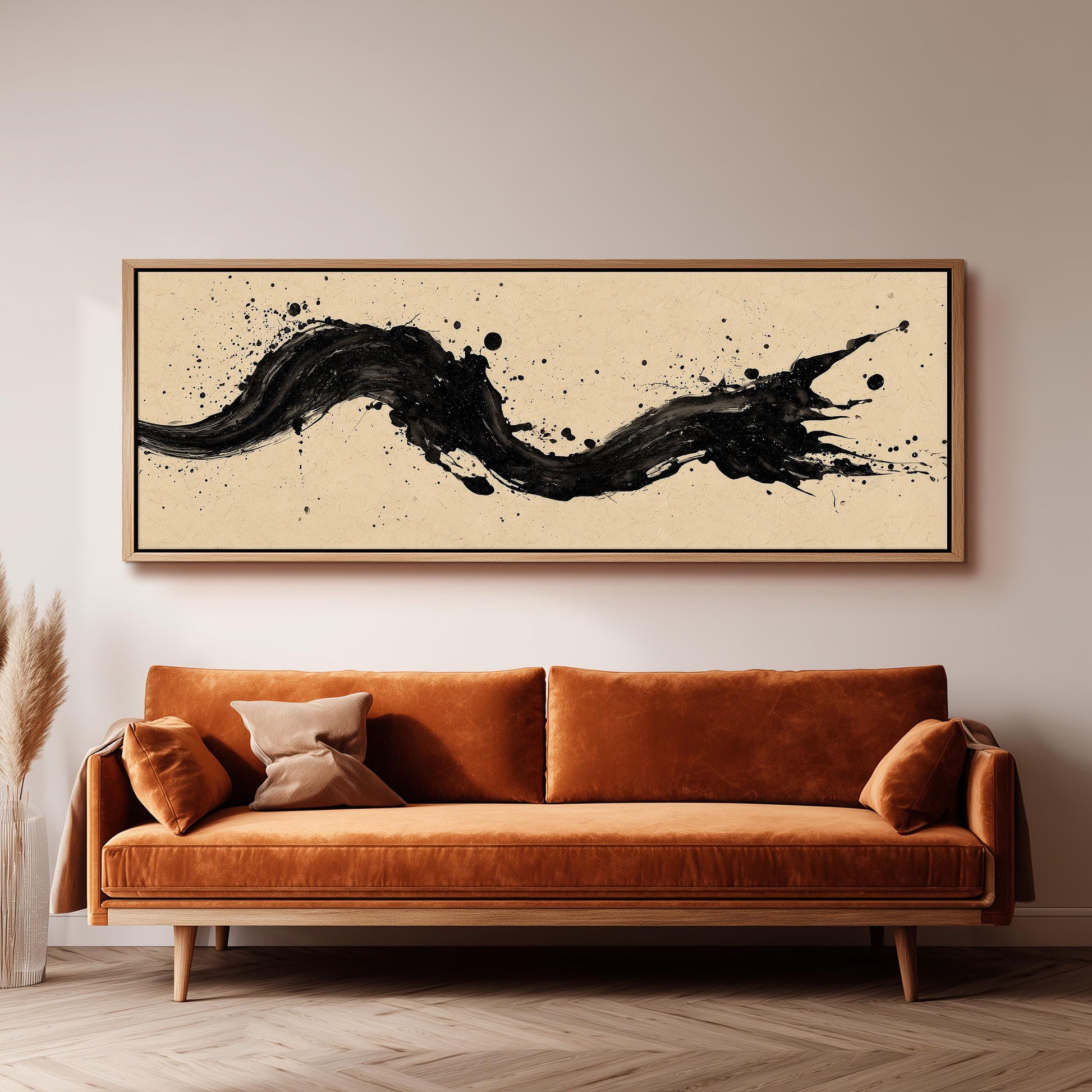 a large, abstract painting hanging on a wall above a brown sofa with orange cushions.