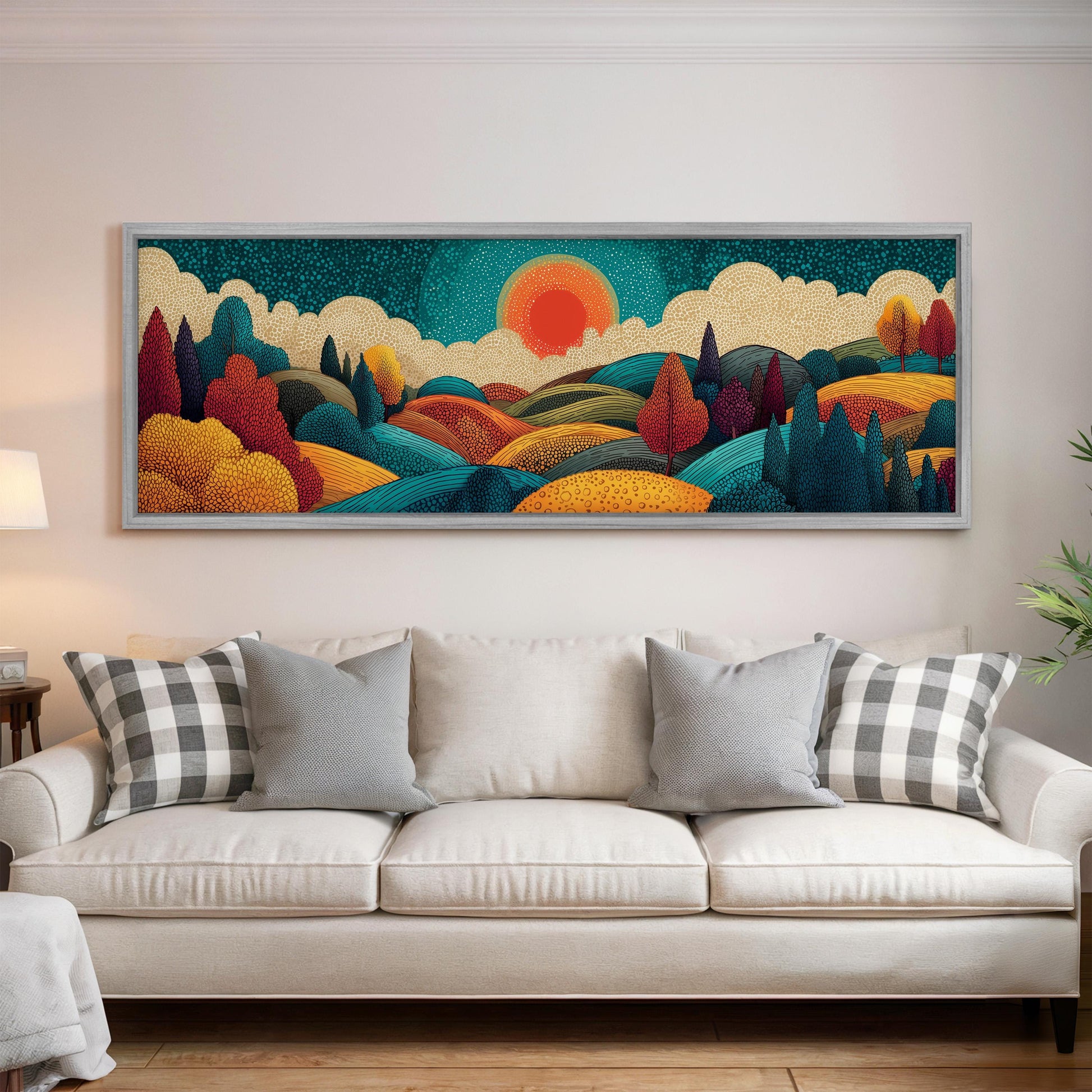 a large, colorful landscape painting hanging on a wall above a white couch with gray and white plaid throw pillows.
