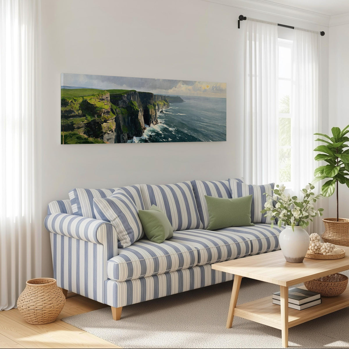 Emerald sea cliffs long horizontal canvas print above a striped sofa in a coastal living room