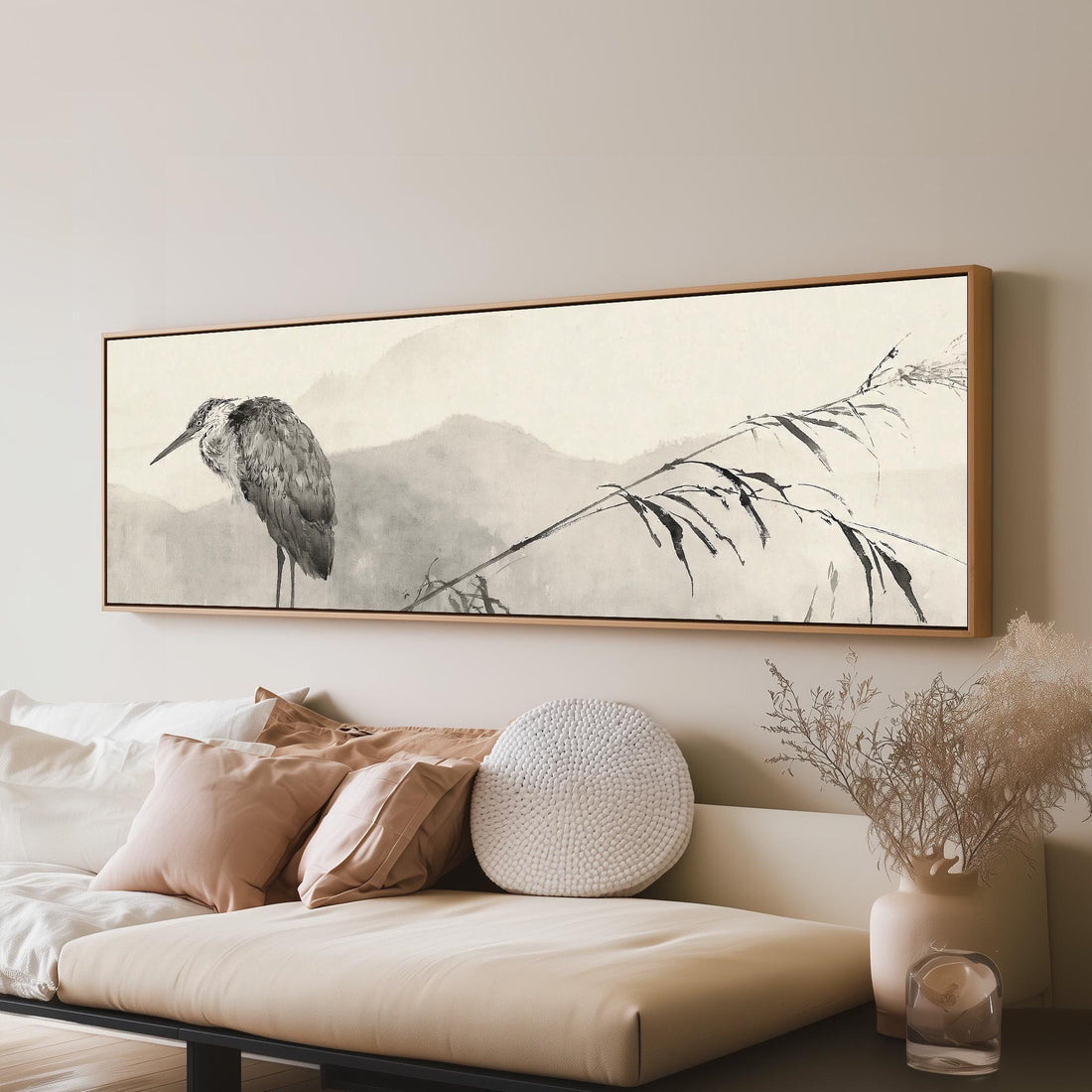 Heron in front of misty ink mountains long horizontal canvas print above a sofa in a living room