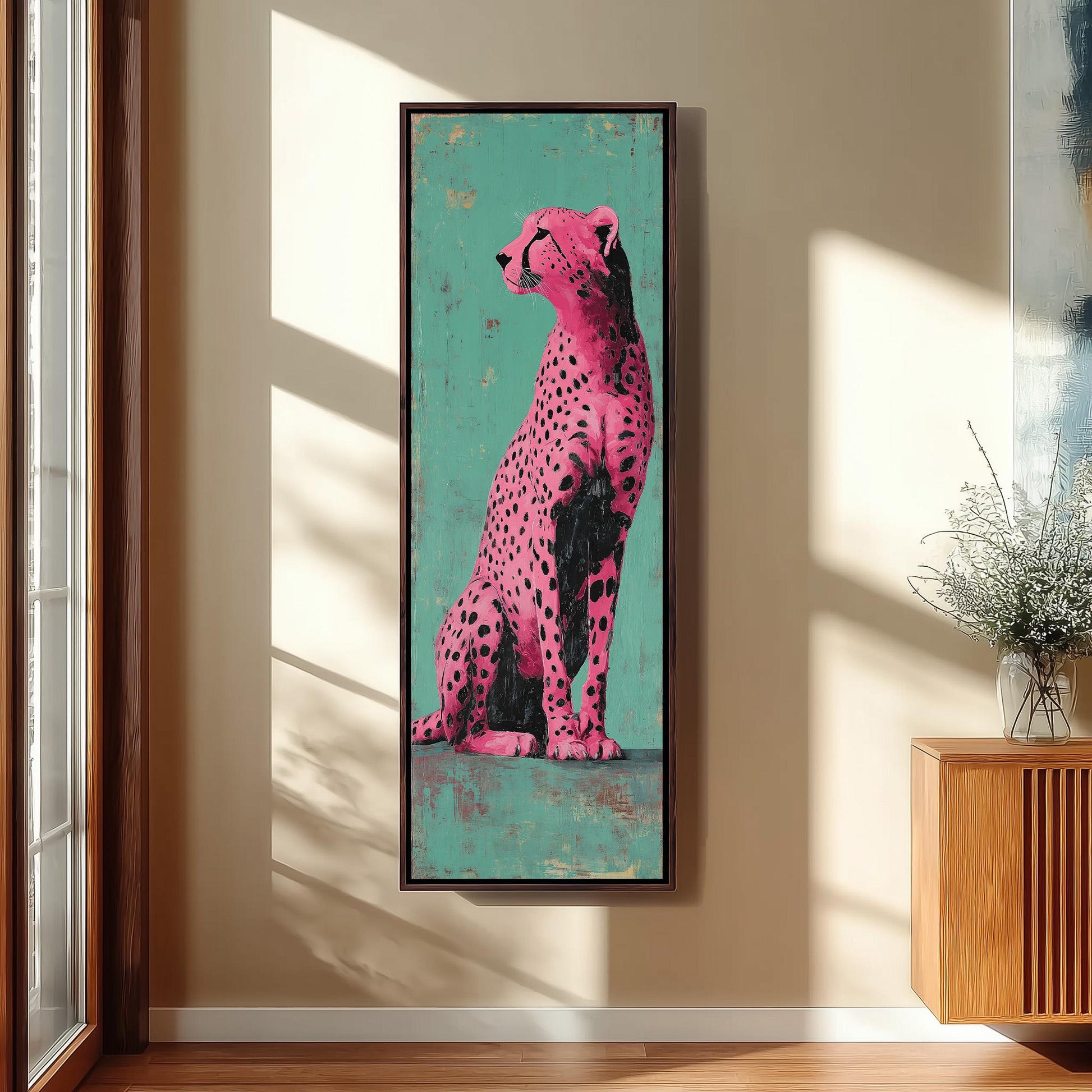 a large, vibrant painting of a cheetah in a pink and black color scheme, hanging on a wall in a room with a wooden cabinet and a vase of flowers.