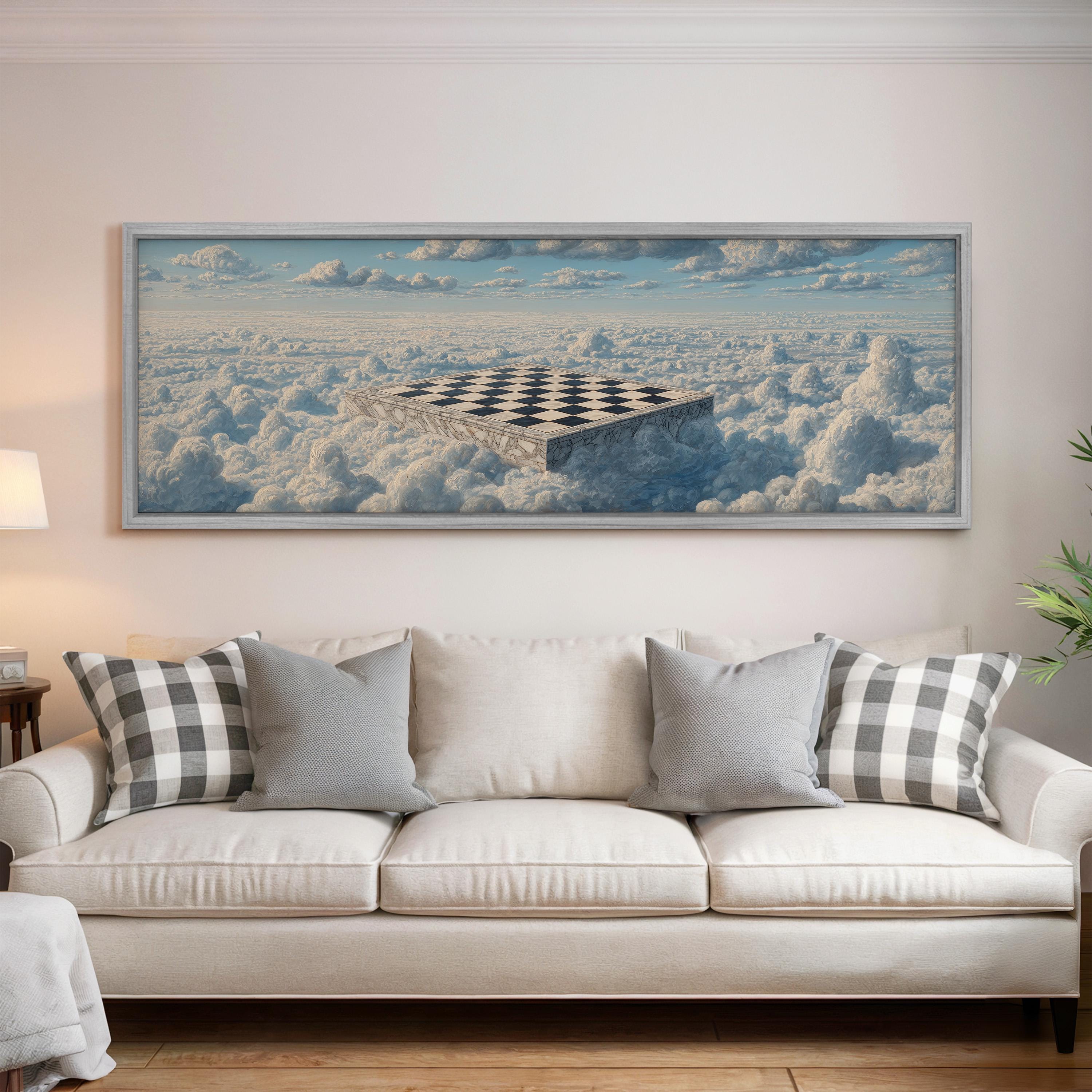 a large painting of a checkerboard on a wall above a white couch with gray and white pillows.