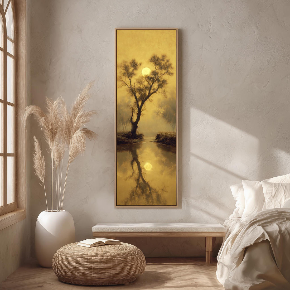 a large framed painting hanging on a wall, depicting a serene landscape with a tree and a body of water reflecting the warm, golden hues of the setting sun.