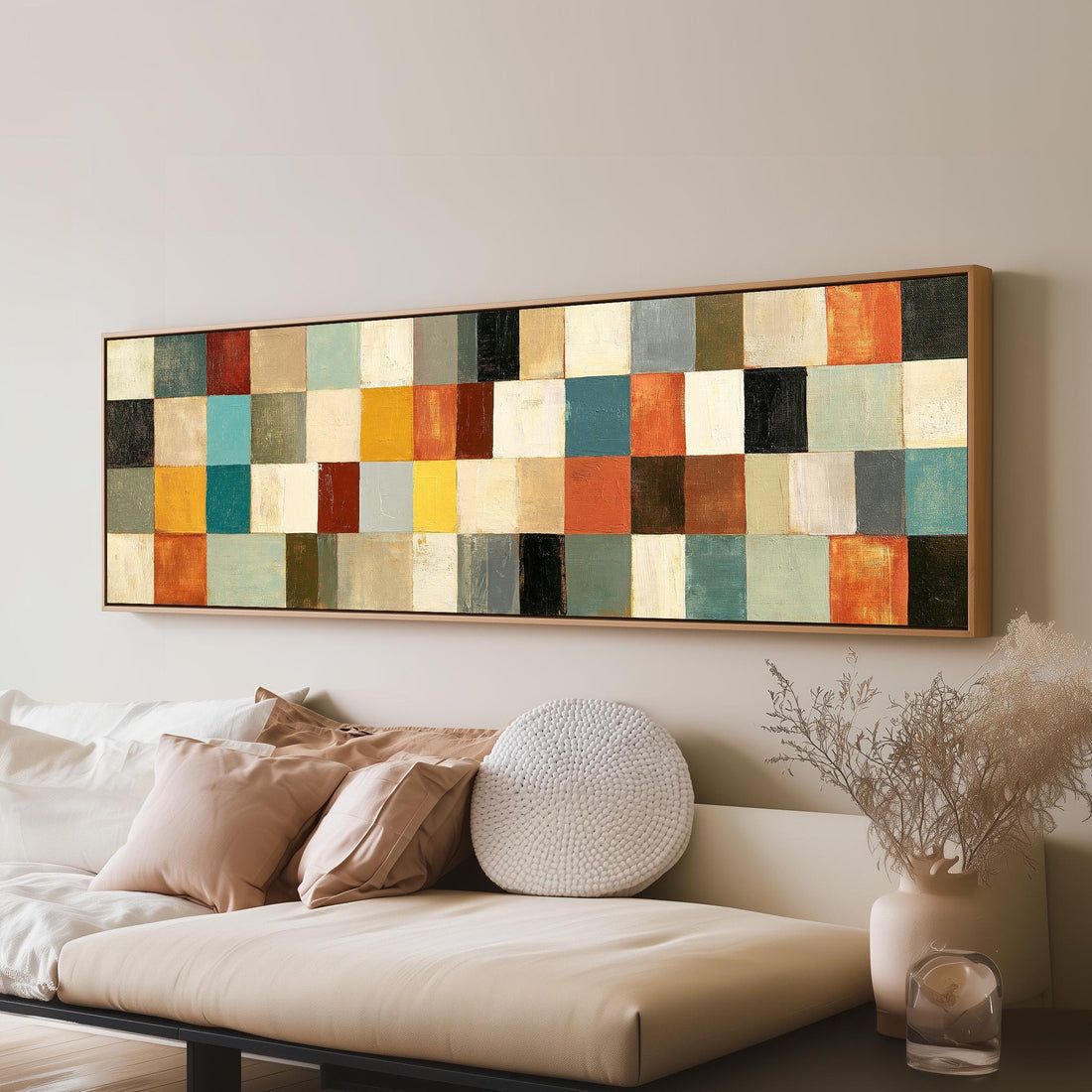 Colorful checkerboard mosaic grid long horizontal canvas print above a sofa in a living room