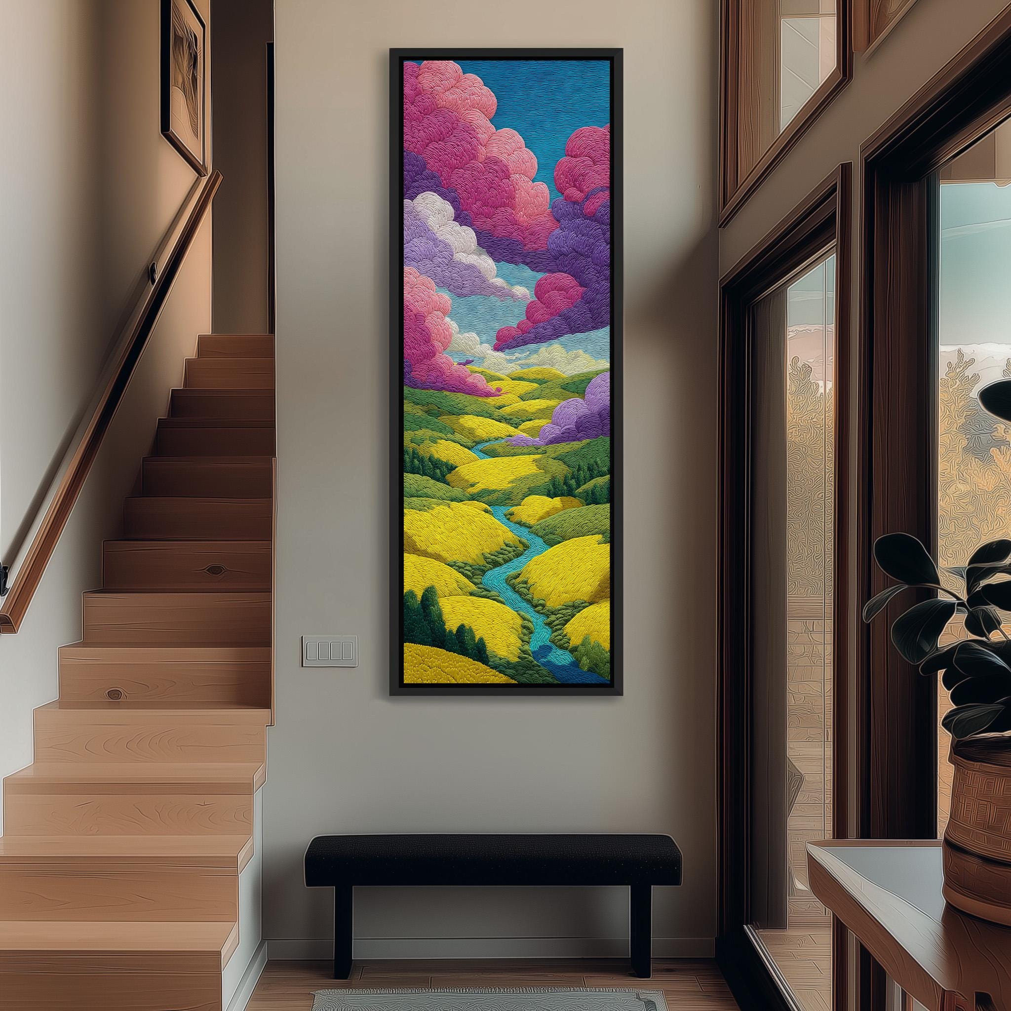 a large, colorful painting of a landscape hanging on the wall of a hallway. The painting depicts a vibrant scene with a winding path leading through a field of yellow flowers, surrounded by a blue sky with fluffy white clouds. The painting is framed and hangs prominently on the wall, adding a touch of artistic flair to the space.