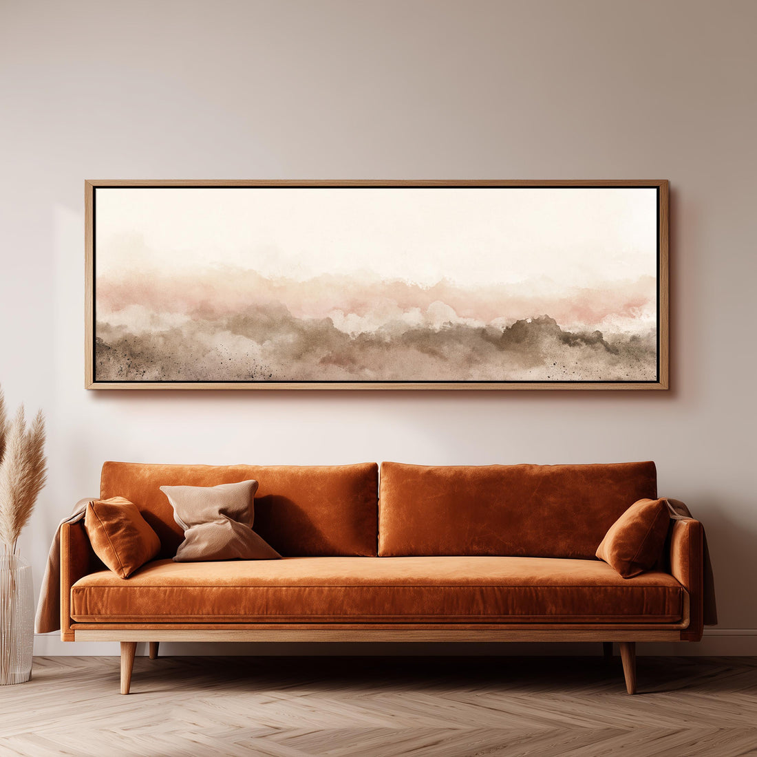 Blush watercolor mountain silhouette long horizontal canvas print above a sofa in a living room