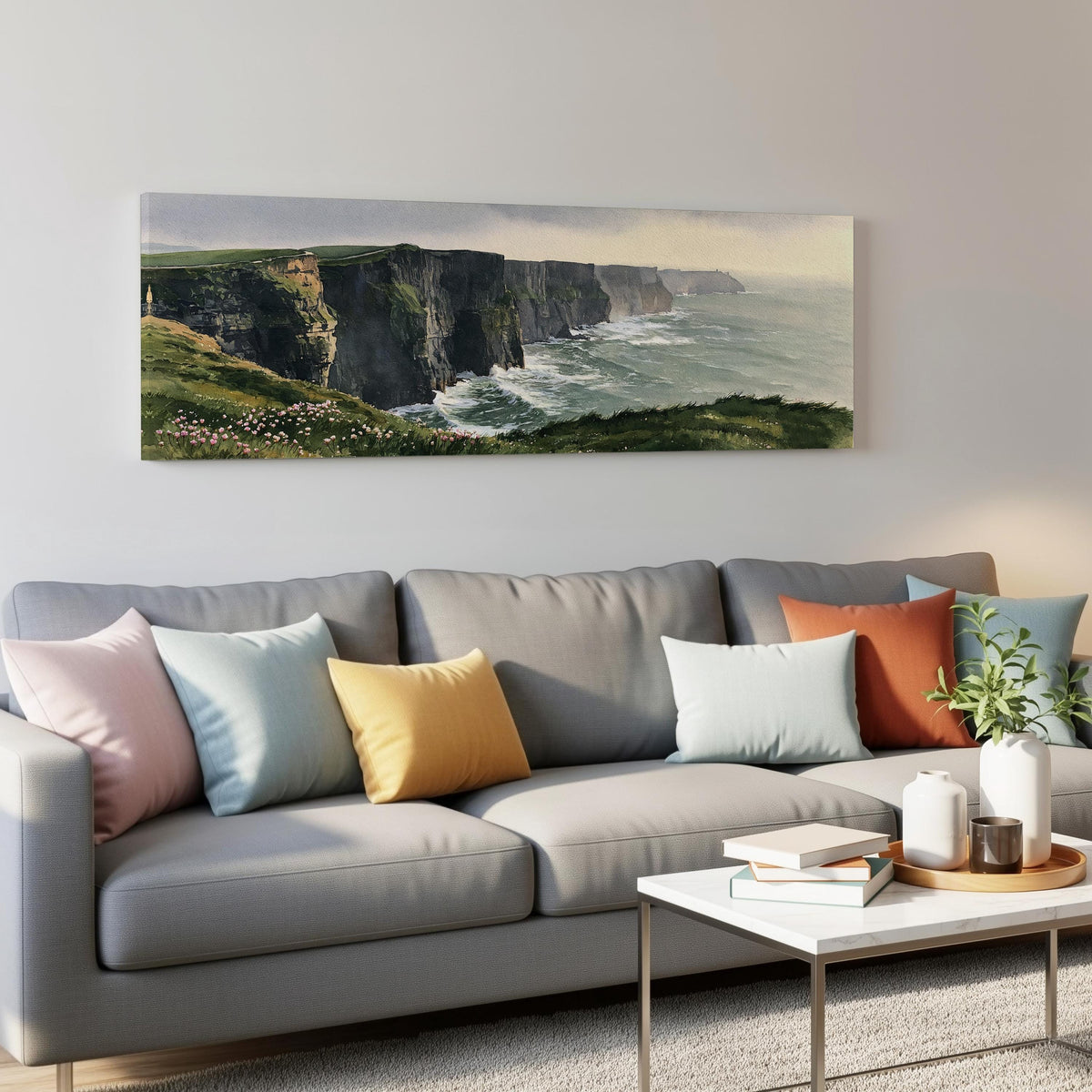 Green sea cliffs with wildflowers panoramic canvas print above a grey sofa in a living room