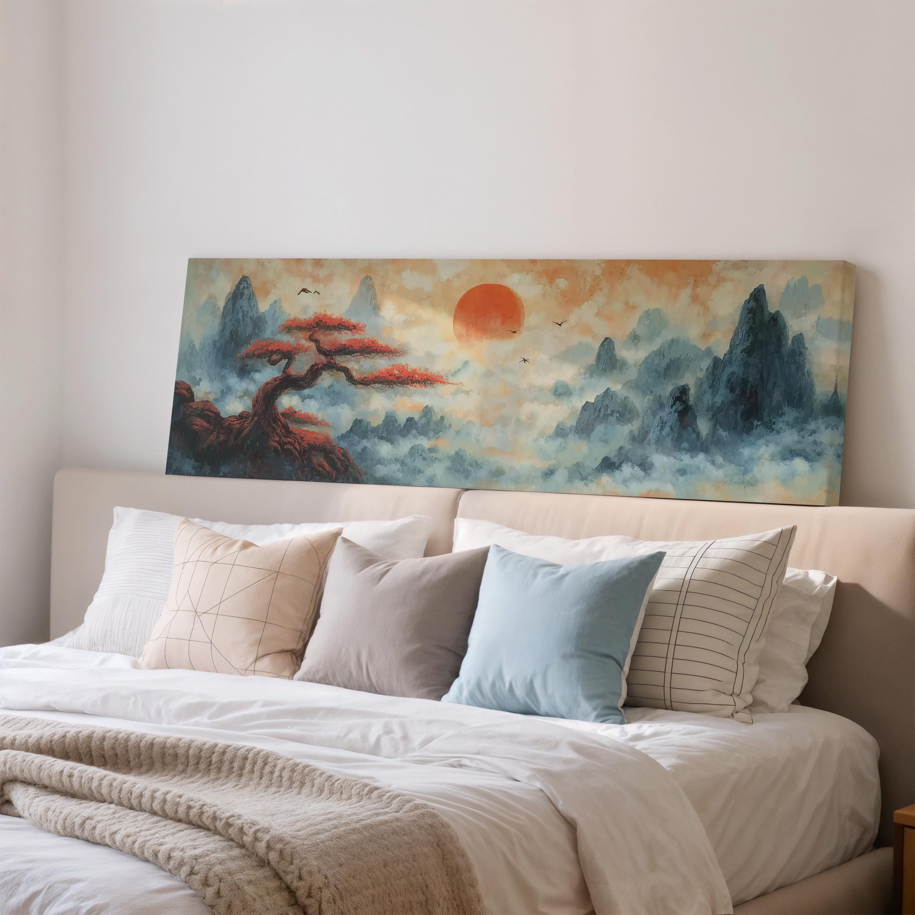 a large painting of a landscape with a tree and mountains, hanging on a wall above a bed with white bedding and pillows.
