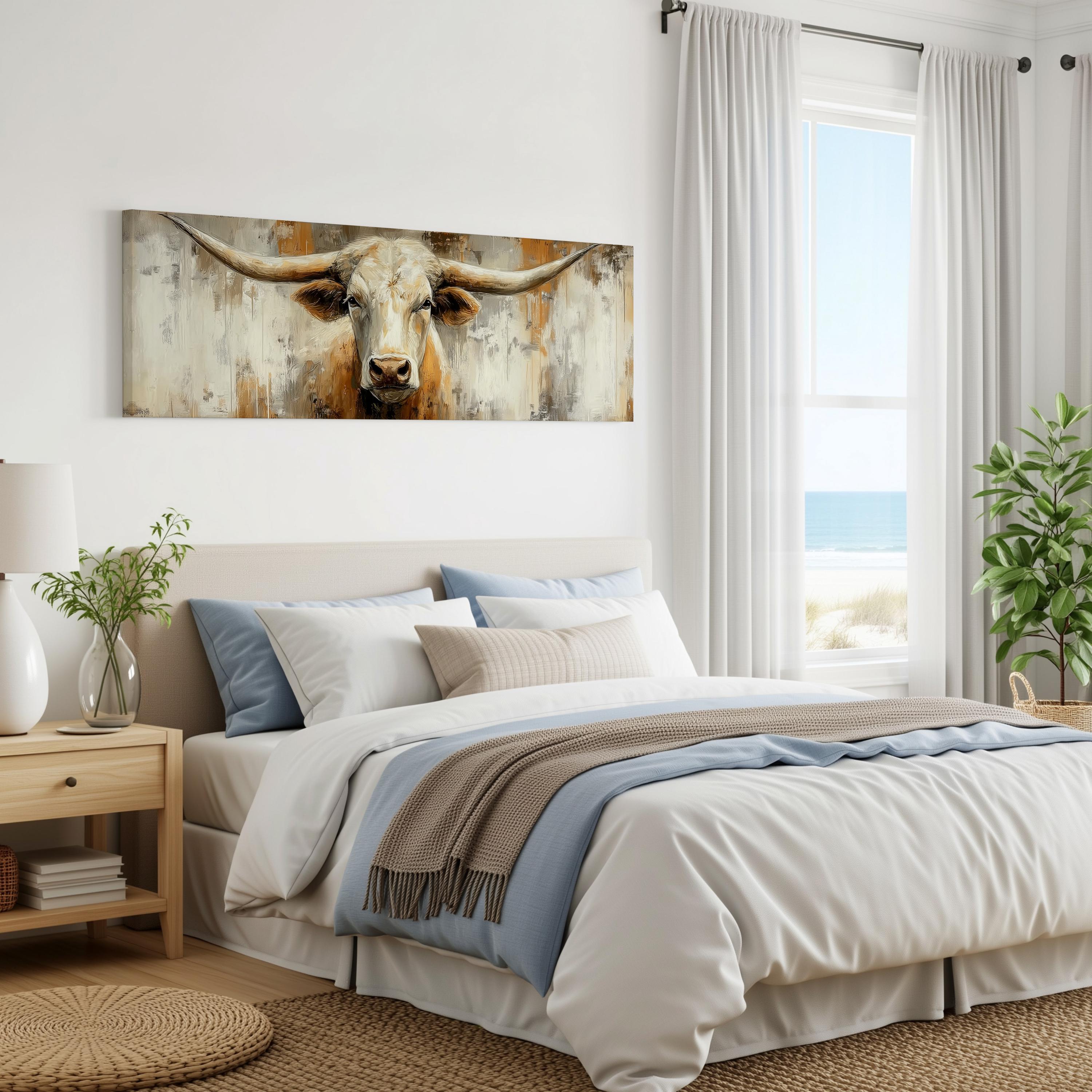 a serene bedroom scene with a large bed, a painting of a bull's head on the wall, and a window overlooking the ocean.