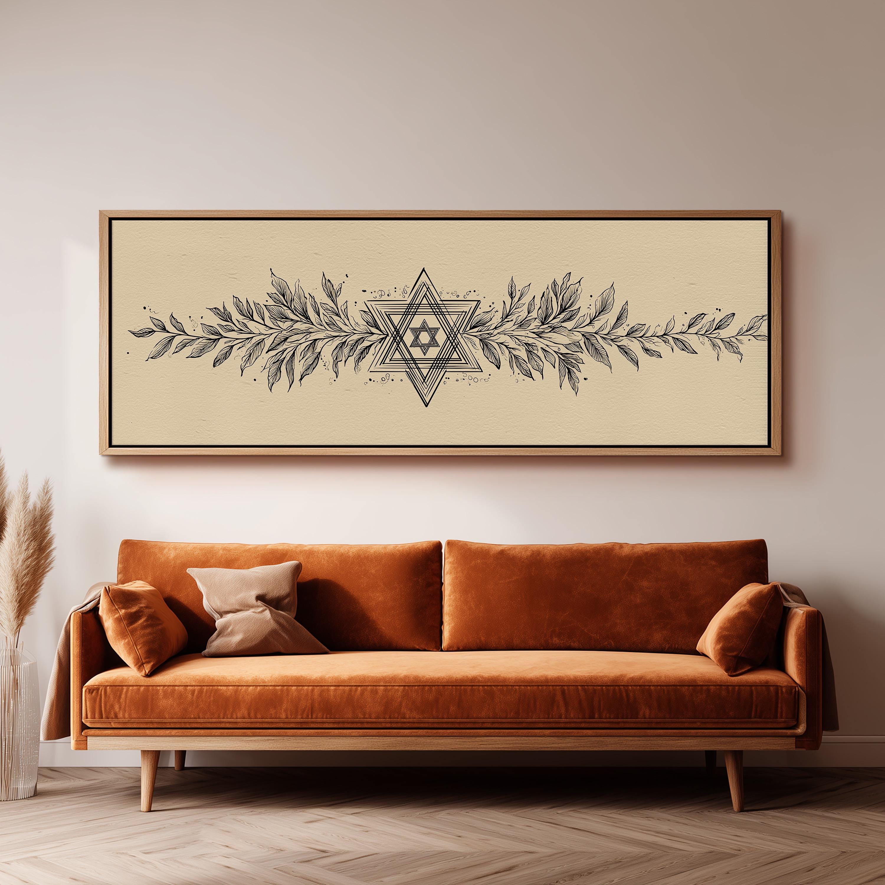 a large, ornate, and detailed painting of a star above a brown sofa with decorative pillows.