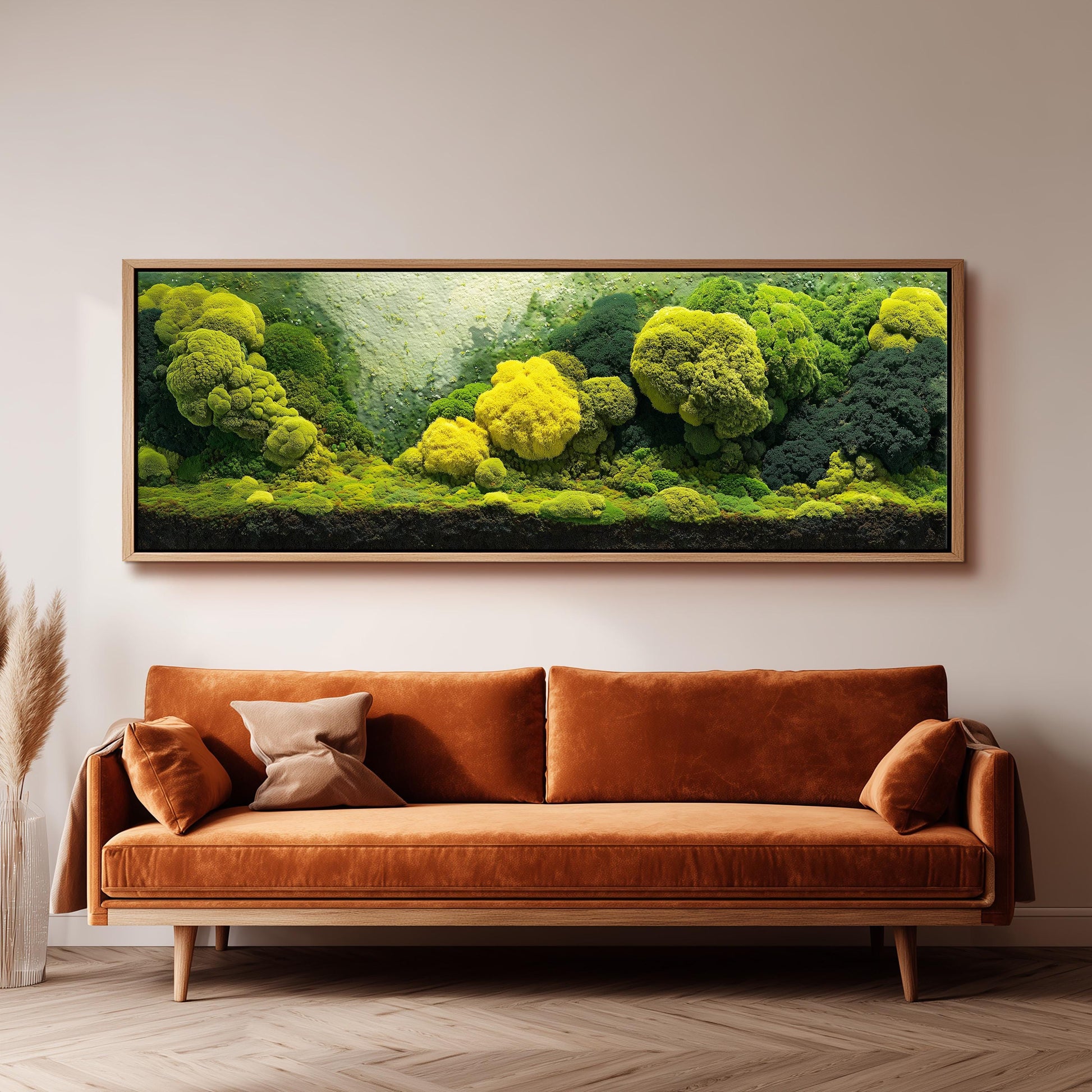 a large, framed painting of a lush, verdant landscape with a variety of green and yellow plants, hanging on a wall above a brown sofa.