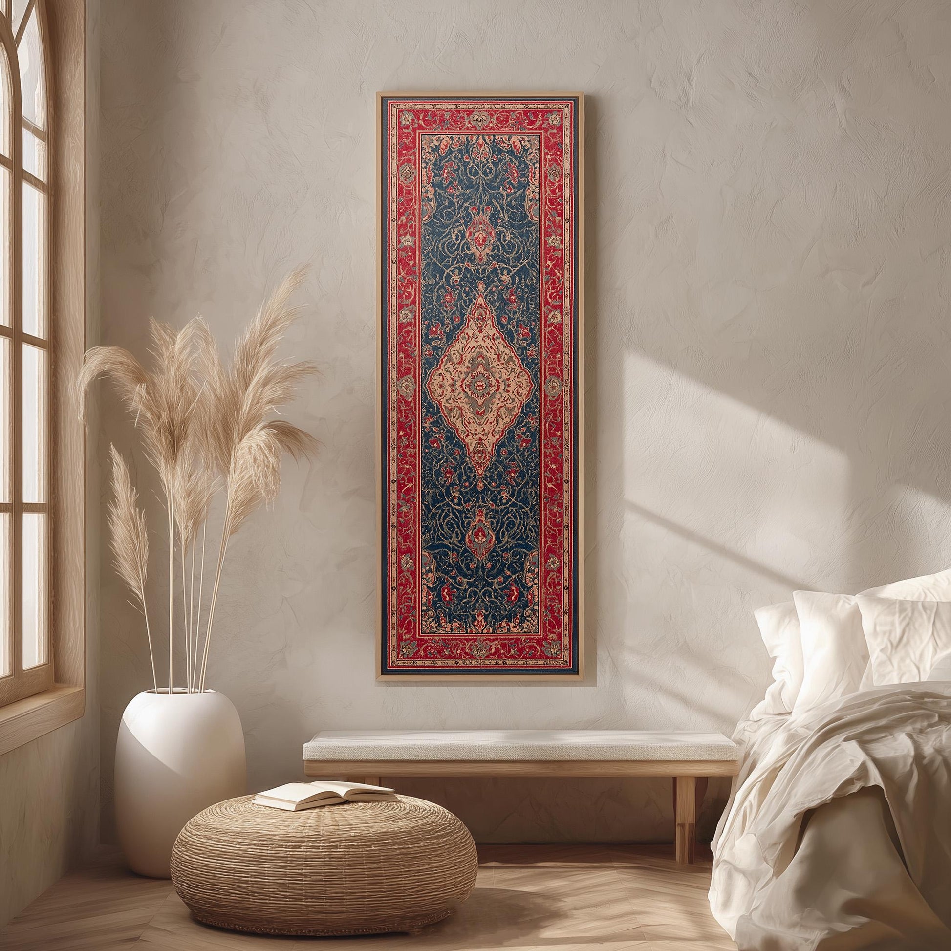a serene and cozy bedroom with a large, ornate rug hanging on the wall, a white bench, a woven ottoman, and a window with white curtains.