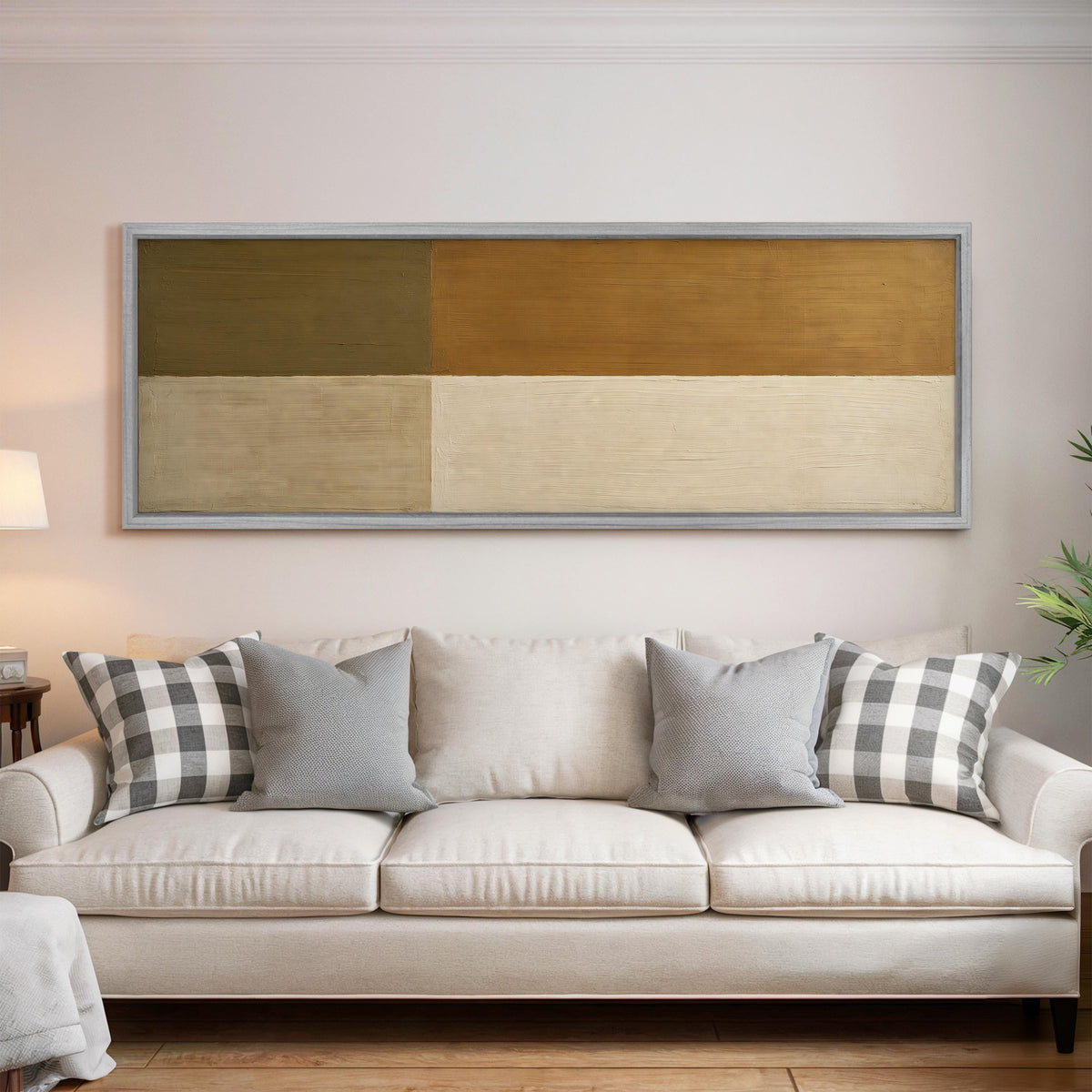 Olive and cream quadrants panoramic canvas print above a white sofa in a bright living room