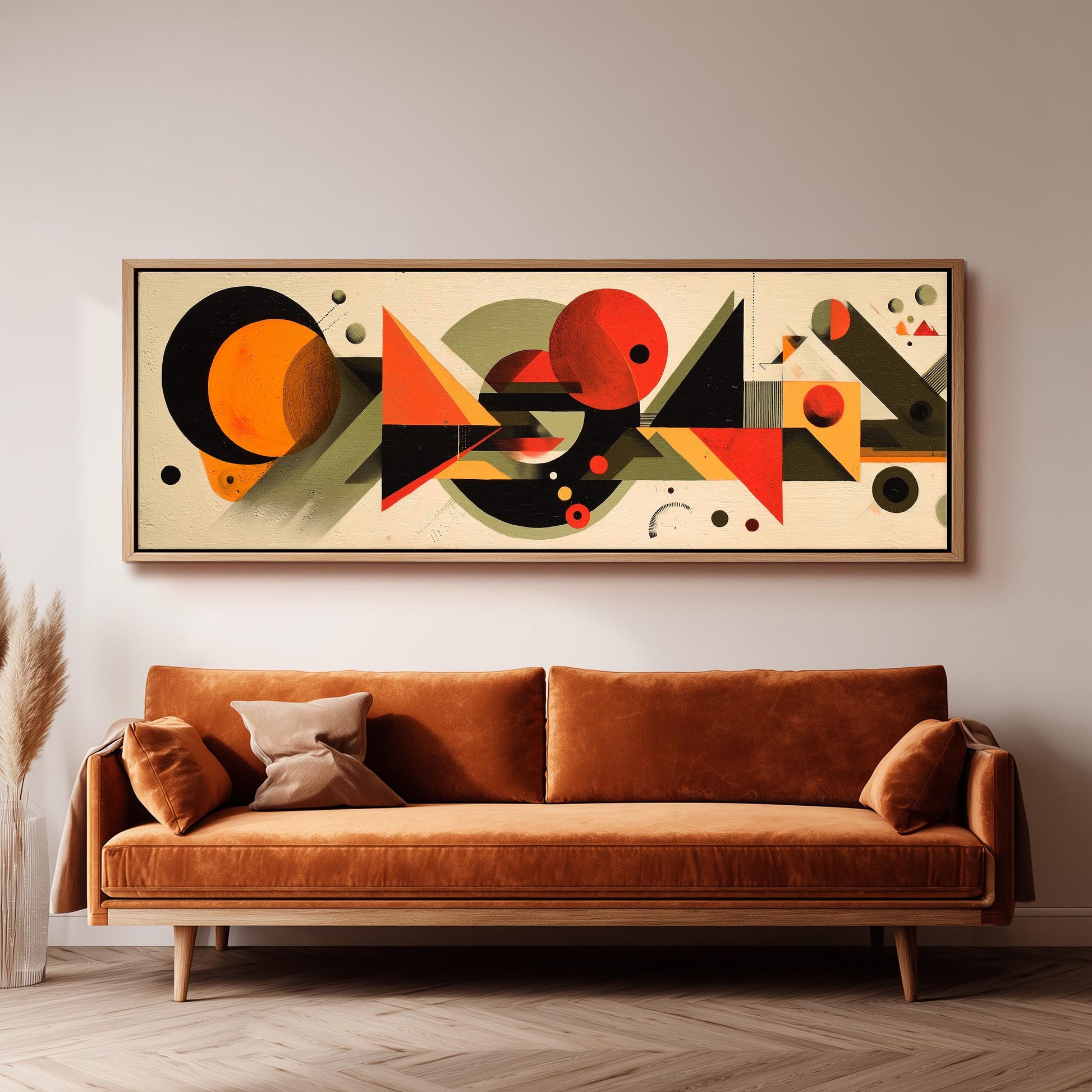 a large abstract painting hanging on a wall above a brown sofa in a living room setting.