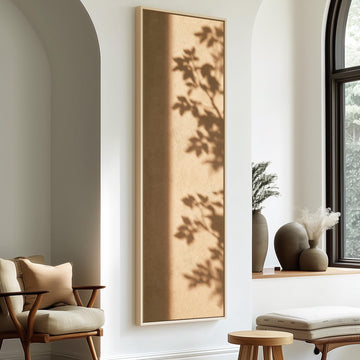 Leaf shadows on a warm tan wall long vertical canvas print in a sunlit living space