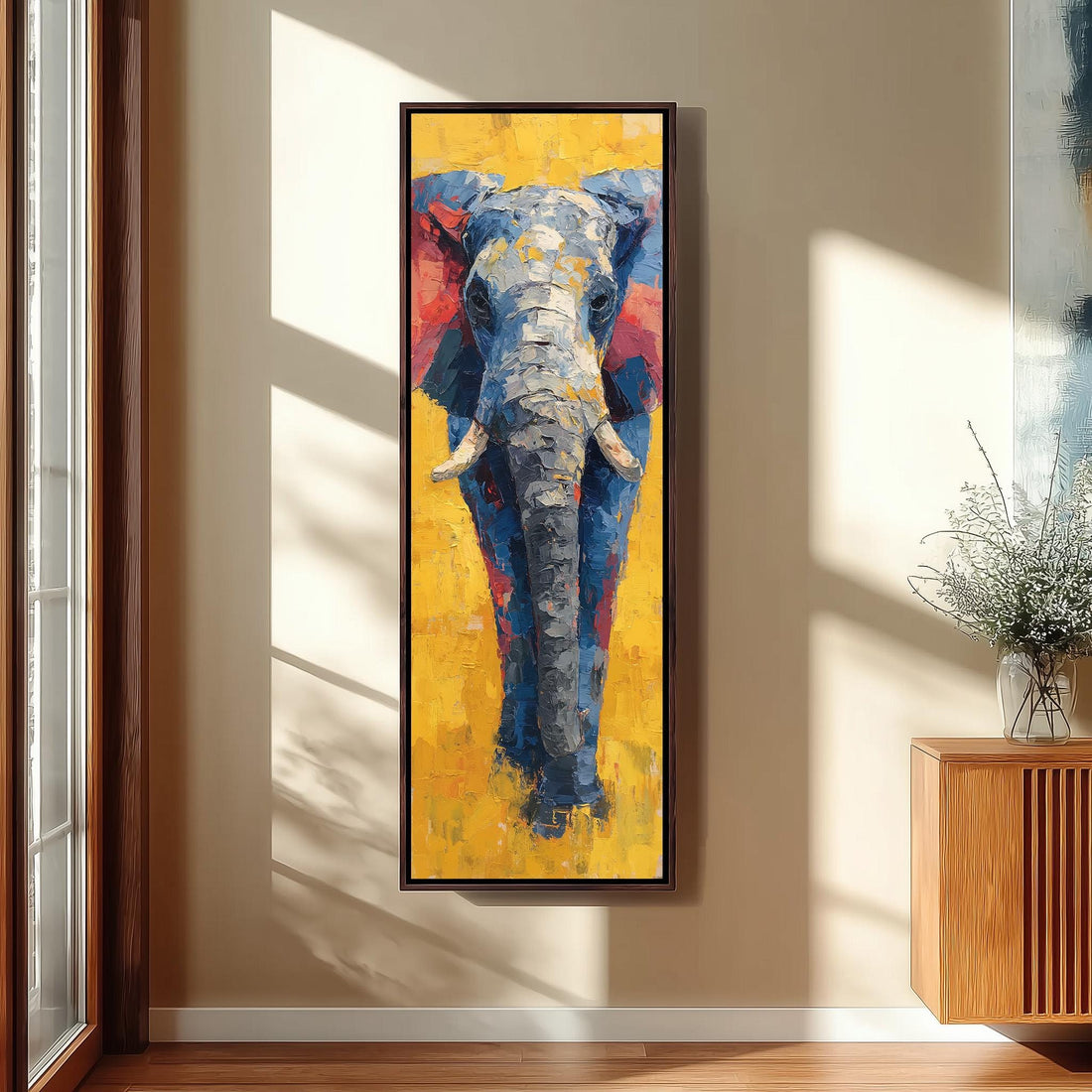 a large, colorful painting of an elephant on a yellow background, hanging on a wall in a room.