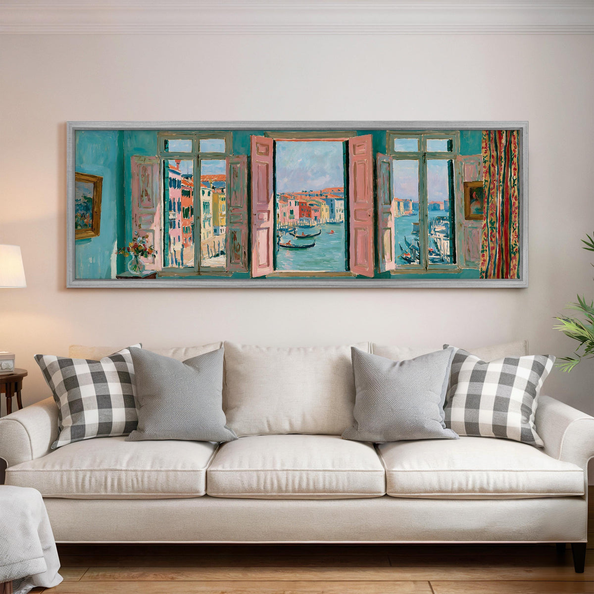 Venice canal and gondolas through a window panoramic canvas print above a white sofa in a bright living room