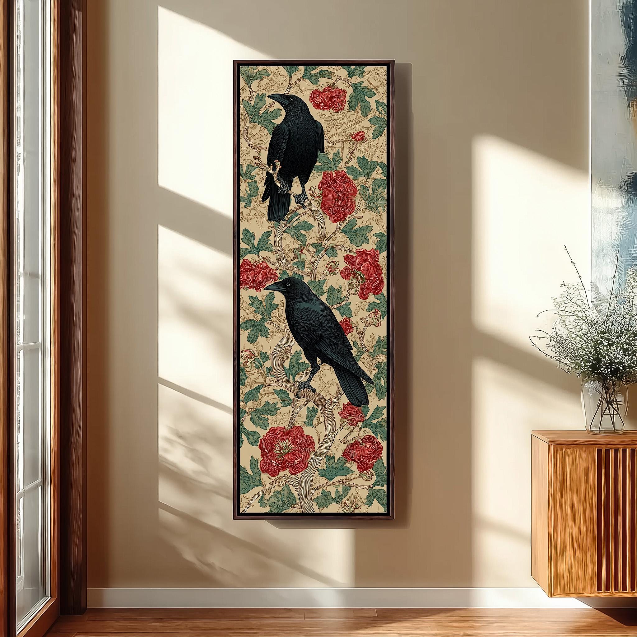 a framed artwork of two black birds perched on a floral background with red flowers.