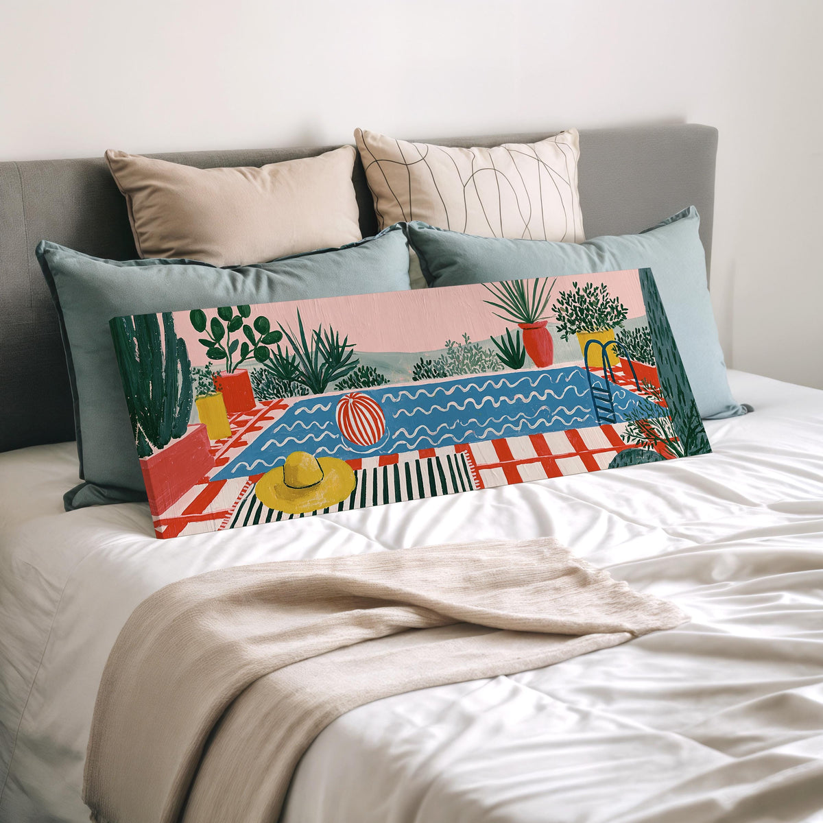 Colorful poolside courtyard wide panoramic canvas print laid on a bed to show its size