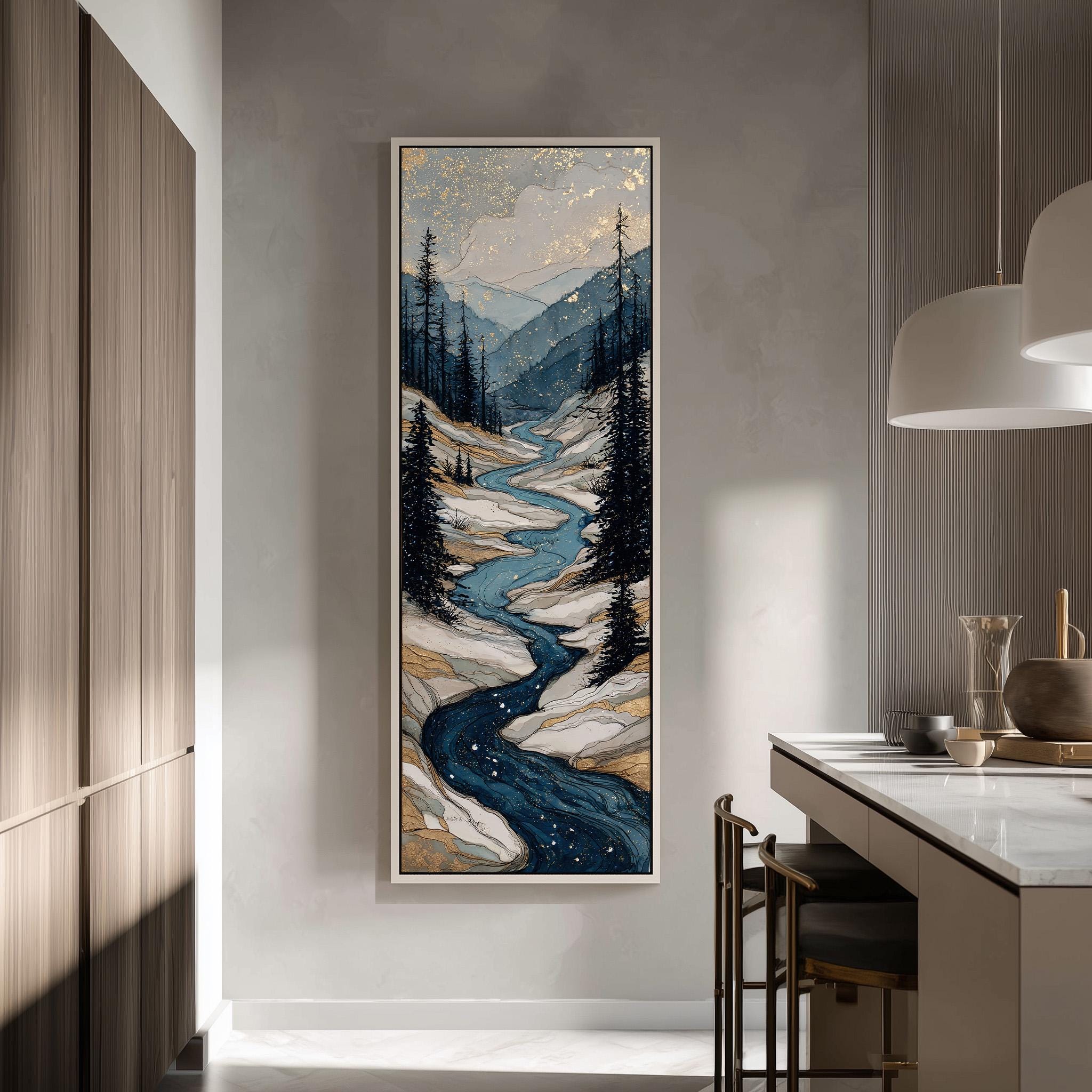 a large, framed painting of a mountain landscape with a winding river, hanging on a wall in a modern kitchen.