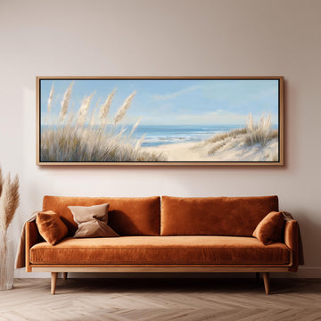 a large painting of a beach scene hanging on a wall above a brown sofa.