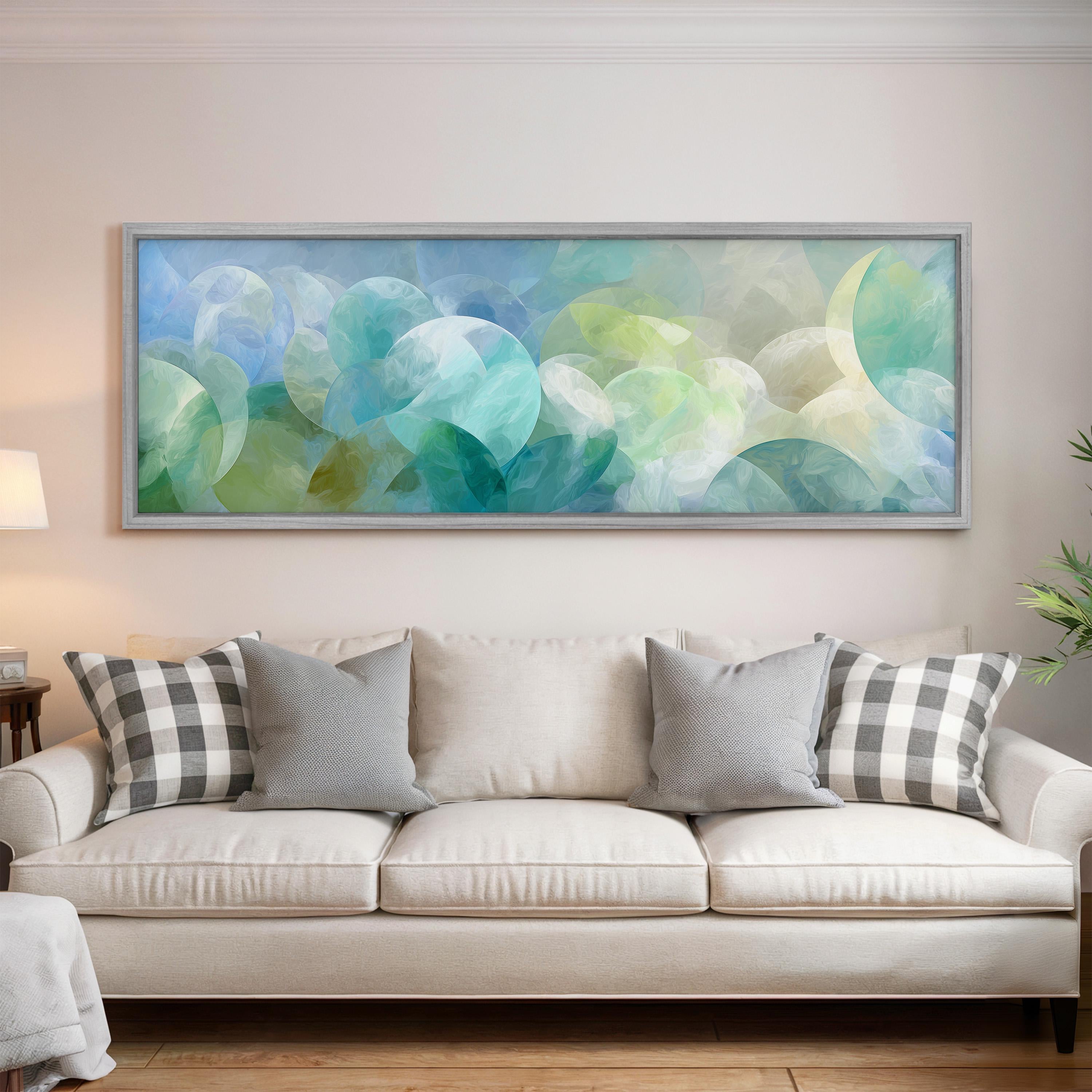 a large, abstract painting hanging on a wall above a white couch with gray and black plaid throw pillows.