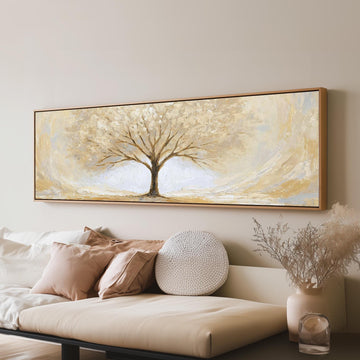 Golden winter tree long horizontal canvas print above a sofa in a living room
