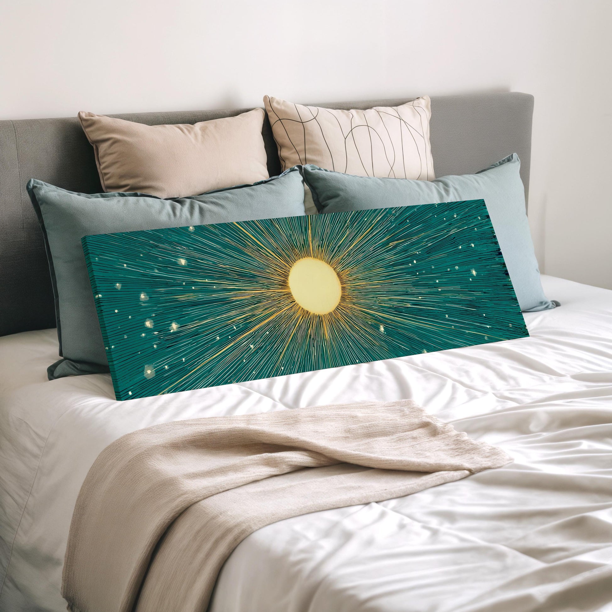 a bed with a large, colorful canvas print featuring a sun-like design in shades of blue and green, resting on a white bedspread.
