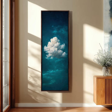 a large framed painting of a cloud hanging on a wall, with sunlight streaming in from a window behind it.