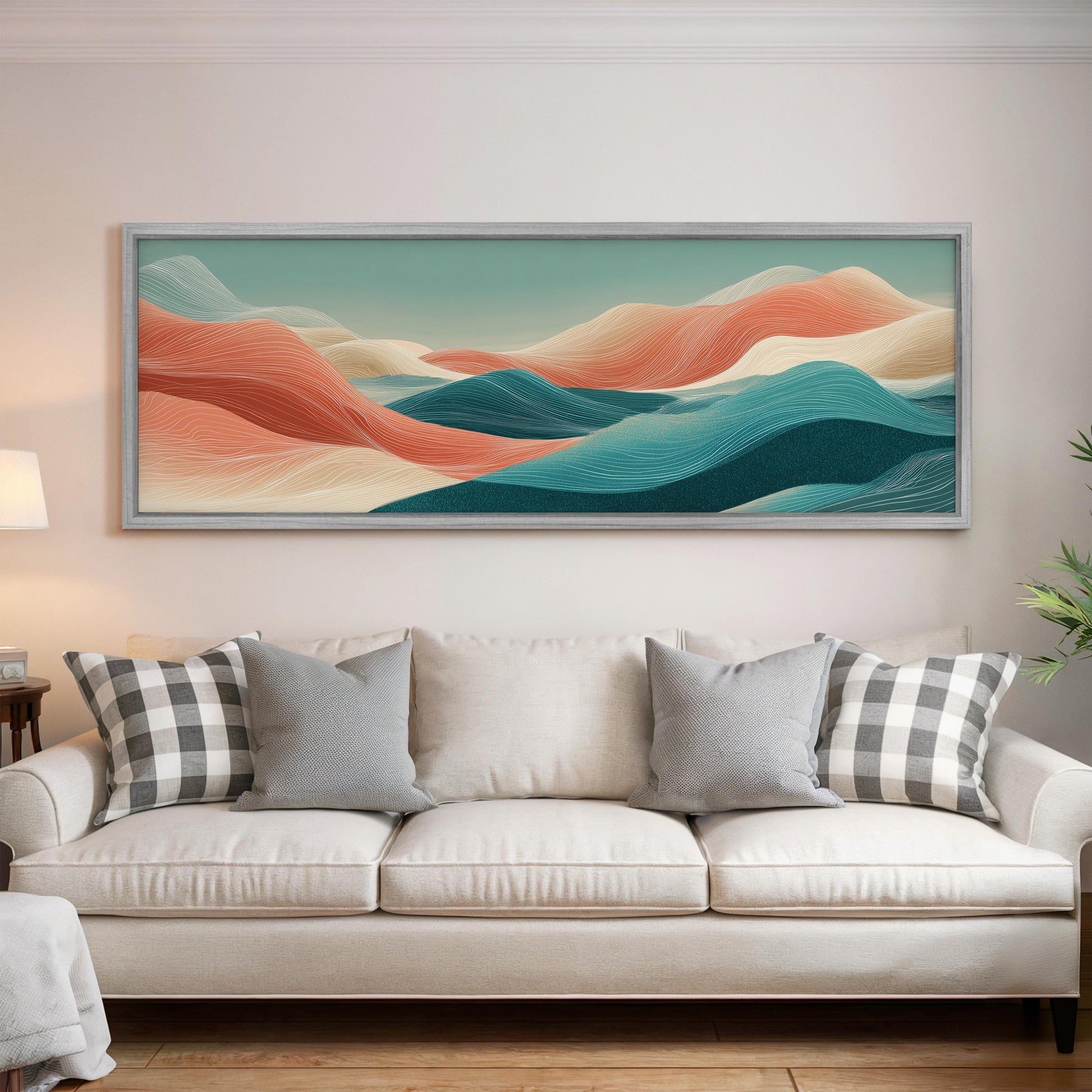 a large, colorful landscape painting hanging on a wall above a white couch with gray and black plaid throw pillows.